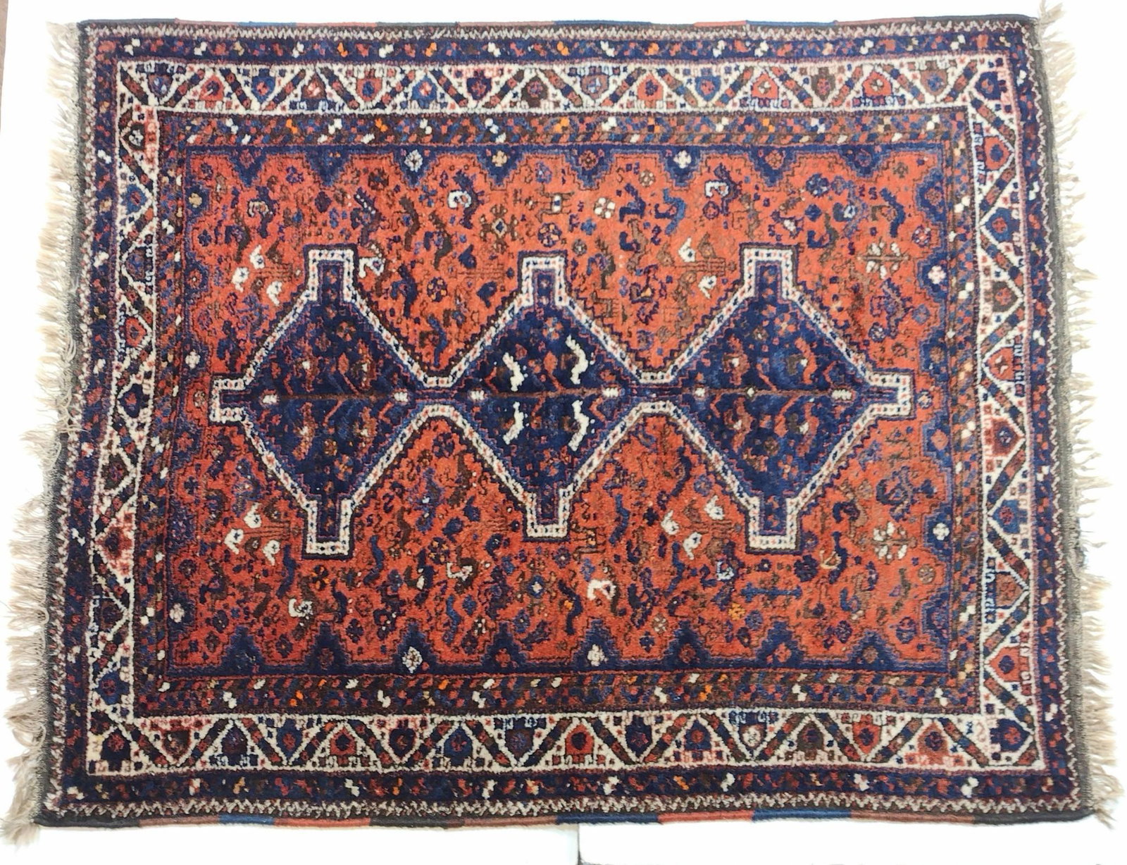 Avakian Bros Persian Area Size Rug: Circa 1960s. Red field. 6'7" long X 5'5" wide. Has some discoloring. MG IMPORTANT: Before bidding, please read the terms and conditions. When you registered for the auction you agreed to these terms a