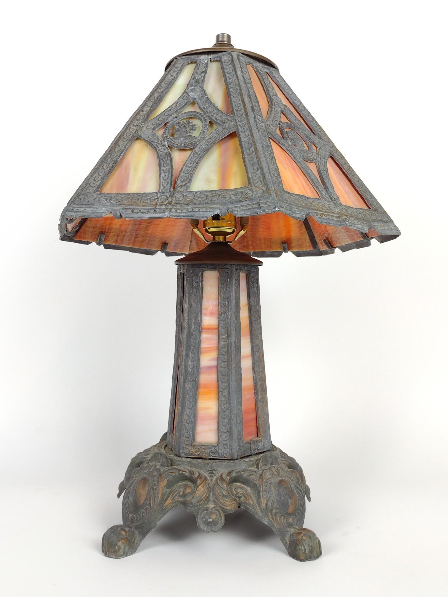 Slag Glass Table Lamp with Figural Embellishments: Working. 19-1/2" high. DM IMPORTANT: Before bidding, please read the terms and conditions. When you registered for the auction you agreed to these terms and will be required to comply with them.
