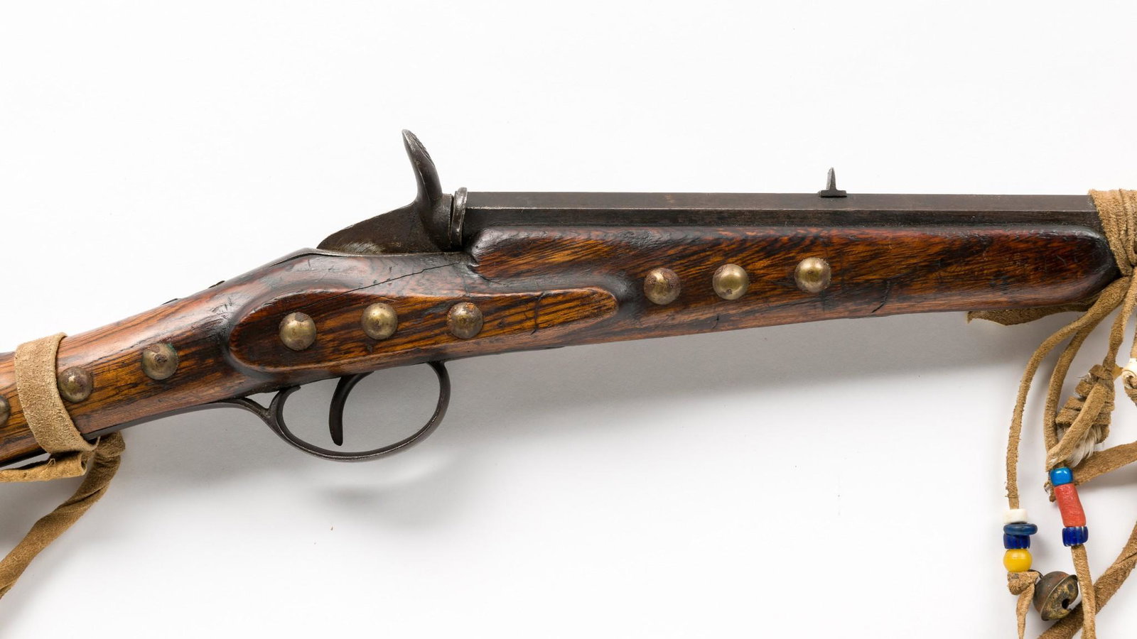 Belgian Flobert-style .22 Single-shot Rifle: Serial Number: NSN Design: Belgian Flobert-style .22 single-shot rifle with a 22-1/4" octagonal barrel. Purported by former owner to be an "Indian child's rifle." Brass tacks applied overall to stock.