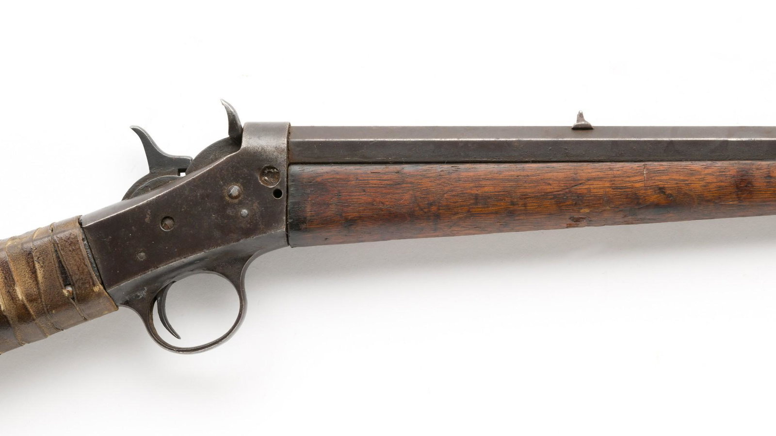 Remington Rolling Block Rifle, Cal. .32rf: Serial Number: NSN Design: 19th Century Remington Rolling Block rifle with a 23-1/2" octagonal barrel, caliber .32 rimfire. Leather stylized "H" with brass tacks at rear of butt. Rawhide and nails use