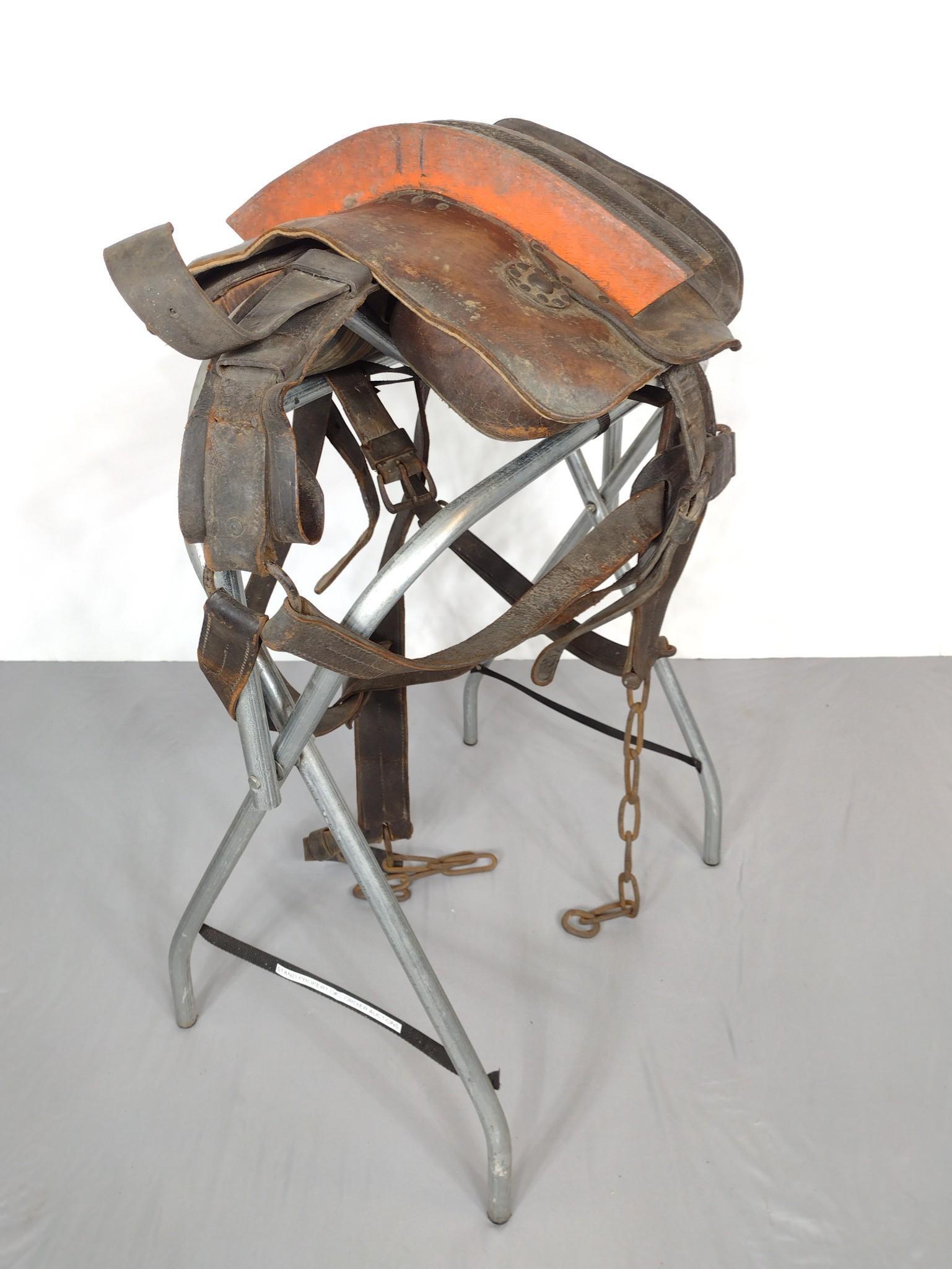 Antique Western Saddle: Brown leather with breeching straps. Has wear. 18" wide X 16" deep X 23" high. Saddle stand not included. MG. PCI-01. IMPORTANT: Before bidding, please read the terms and conditions. When you register