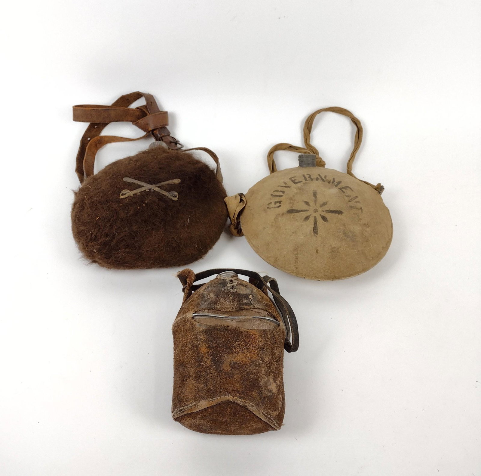 3 Vintage Canteens: BoycoBoy Scout with canvas government cover. Leather and fur covered with calvary insignia. Hide covered. Sizes range 7-1/2" tall to 10" tall and 4-1/2" wide to 9-1/4" wide. MEG IMPORTANT: Before bidd