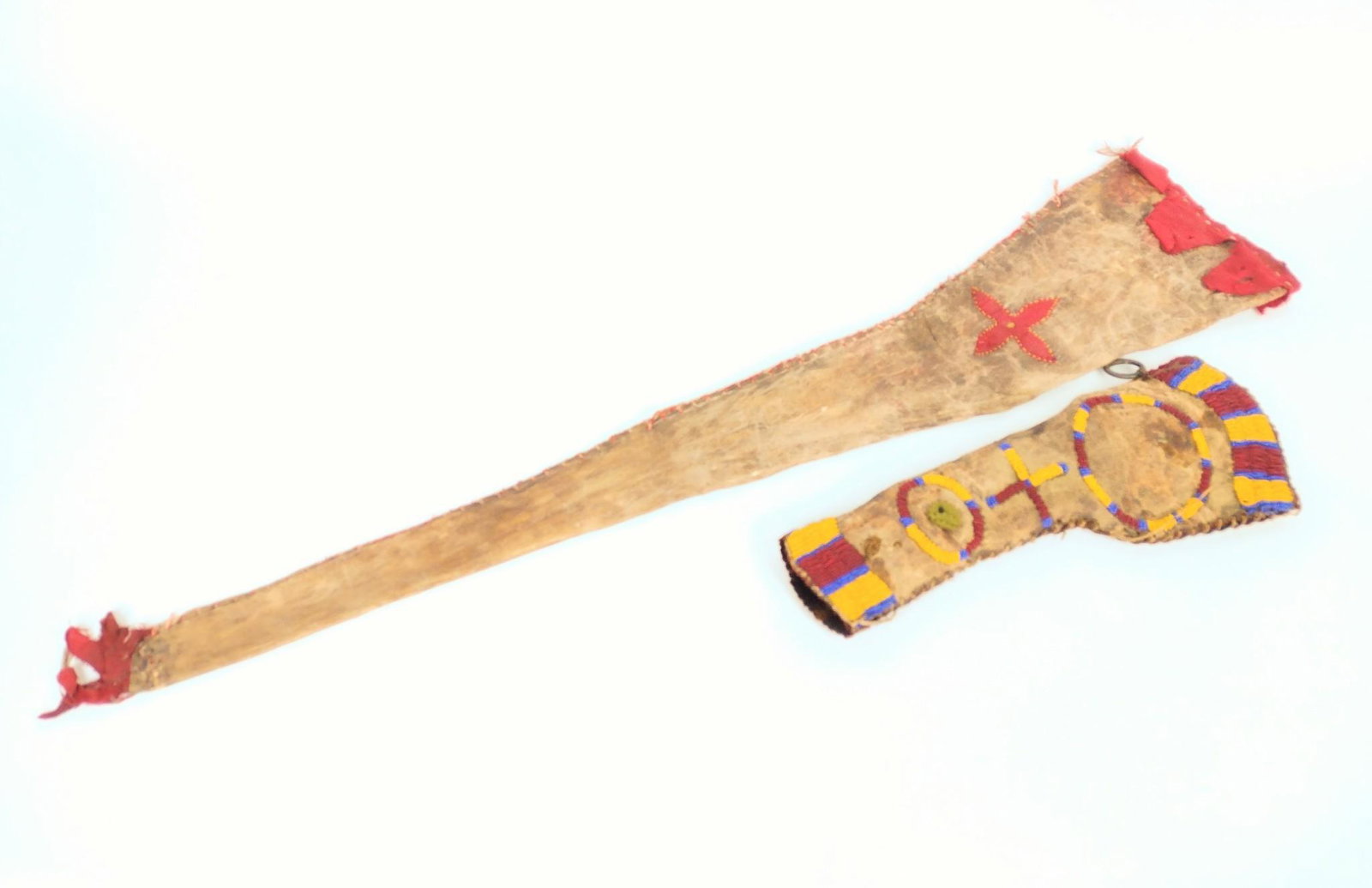 Native American Gun Case & Rifle Case: Includes Western Native American gun case with applied red blanket material, possibly cut from a kapote. Probably northern Plains tribal and early 20th century.38-1/2" long x 8" wide. Also includes Na