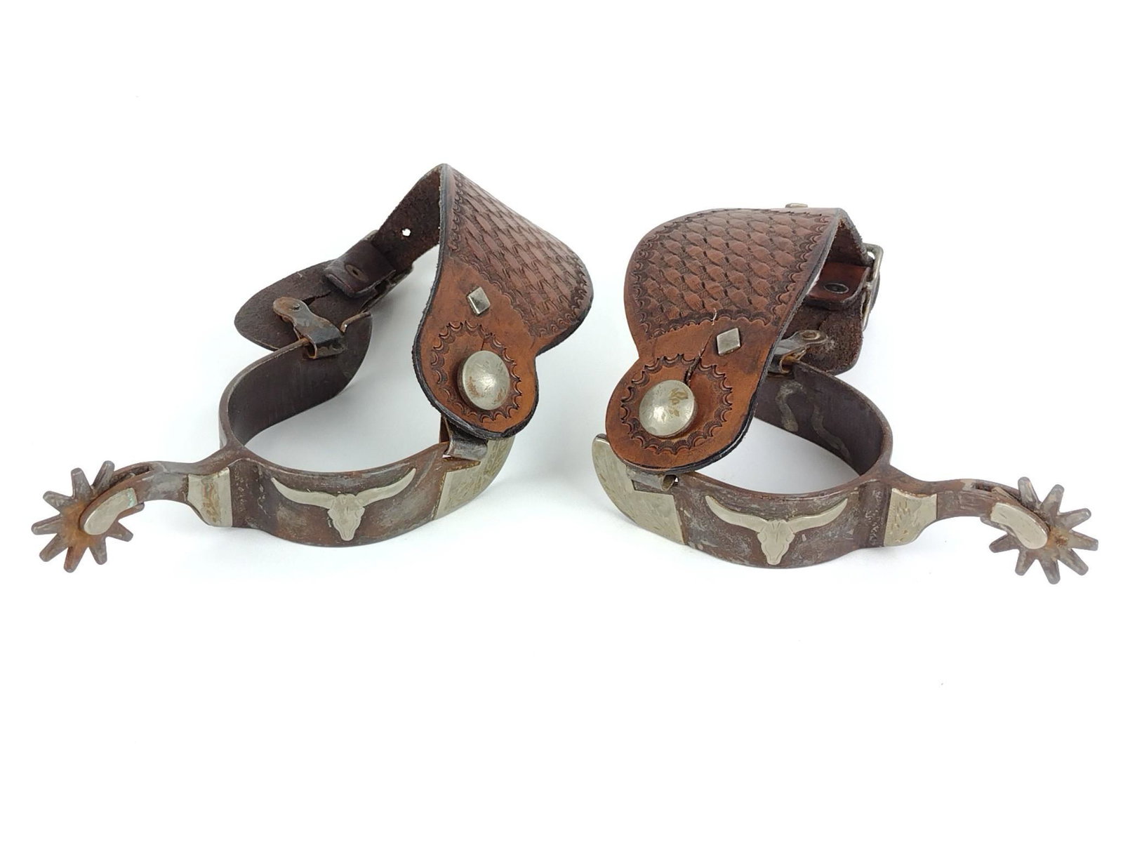 Pair of Spurs with Steer Decoration: Monogrammed "AB". 10" high x 3-1/4" wide. DP. IMPORTANT: Before bidding, please read the terms and conditions. When you registered for the auction you agreed to these terms and will be required to com