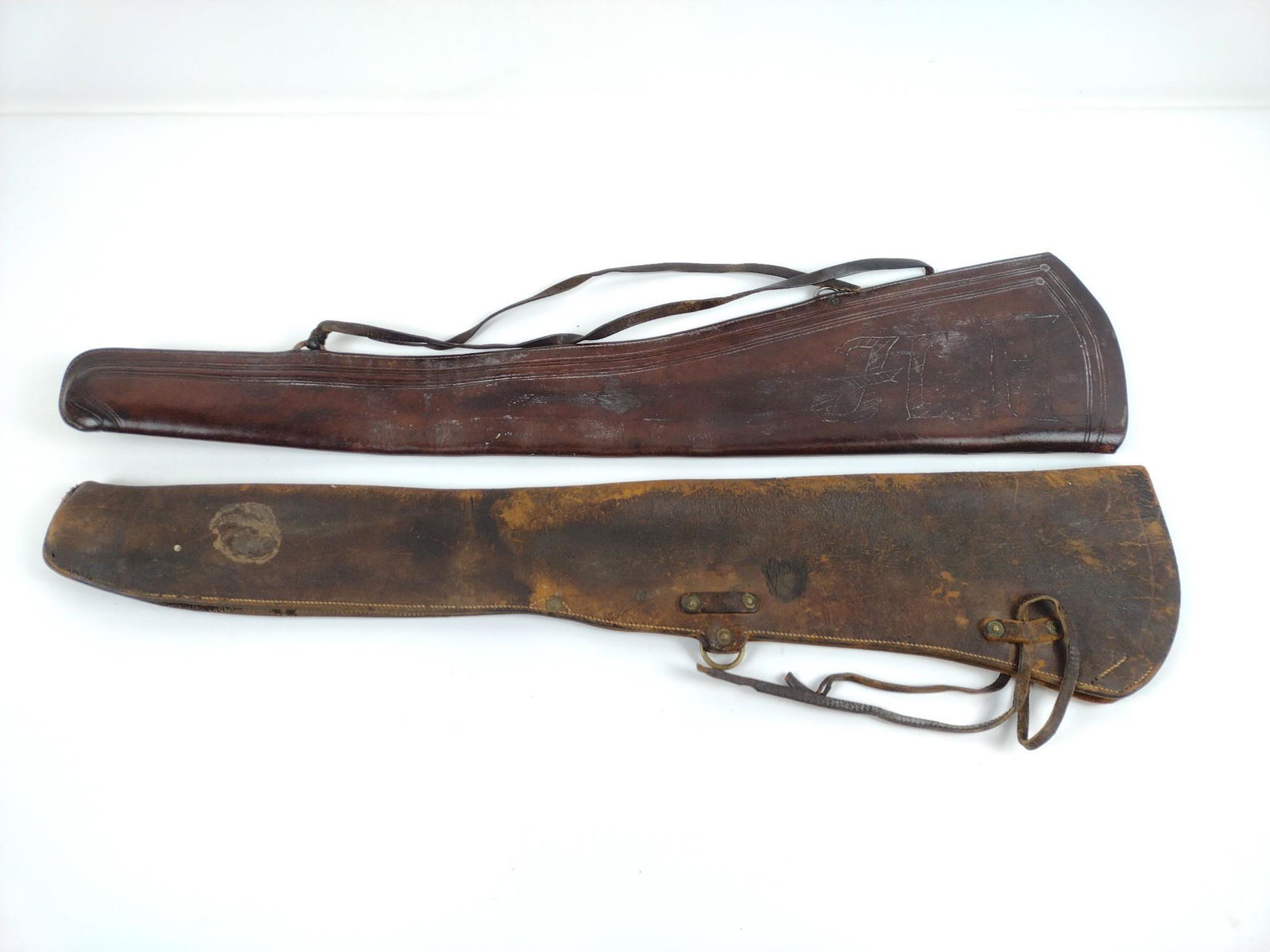 2 Leather Rifle Scabbards: 7" to 7-1/2" wide X 32" long. One etched "JLH". MG. IMPORTANT: Before bidding, please read the terms and conditions. When you registered for the auction you agreed to these terms and will be required