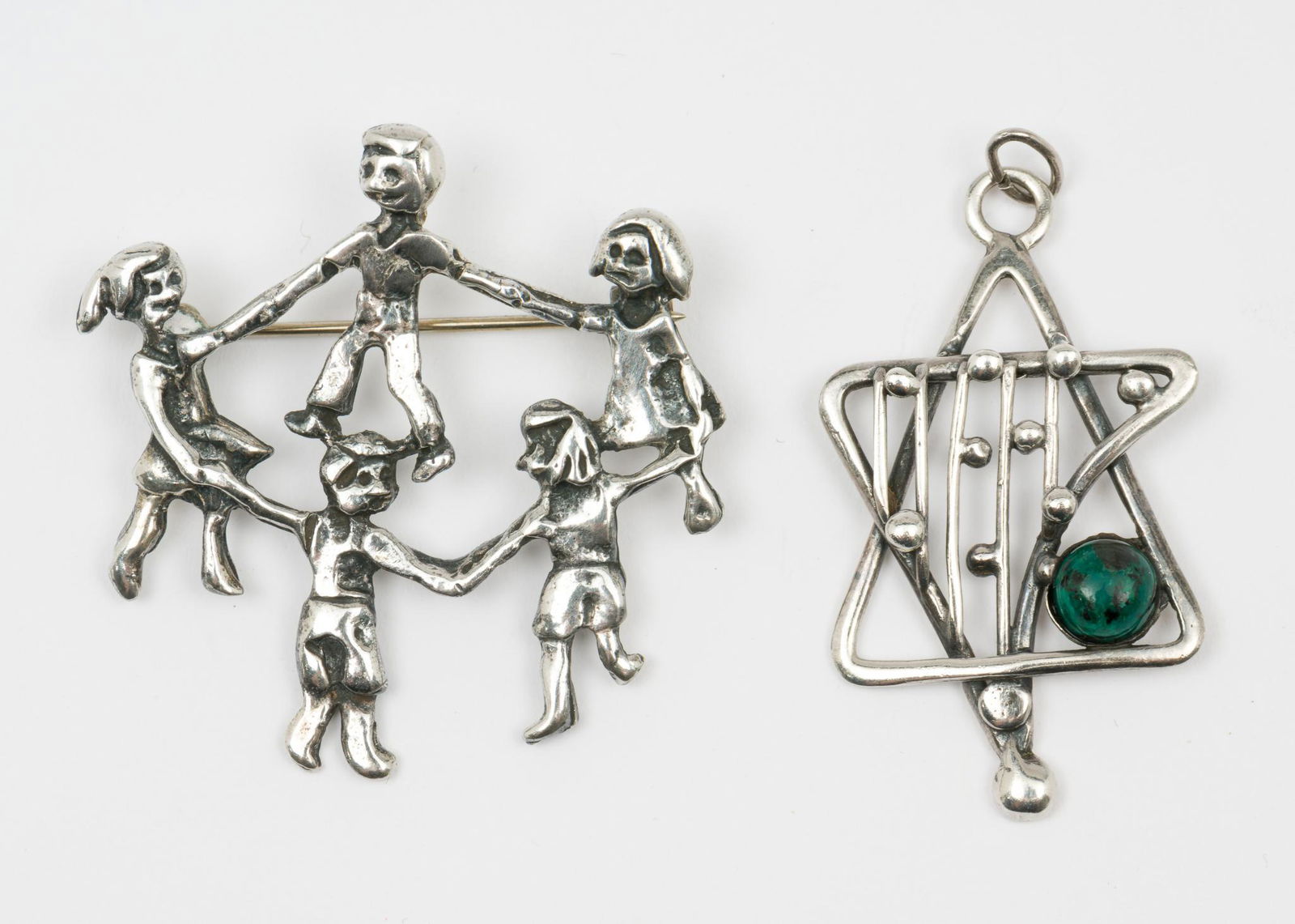 Sterling Pendant & Pin: Both marked sterling. Pendant set with green jasper cabochon. Pin 1-1/2" high x 1-3/8" wide. Pendant 1-1/2" high x 7/8" wide. KE/EK. IMPORTANT: Before bidding, please read the terms and conditions. W