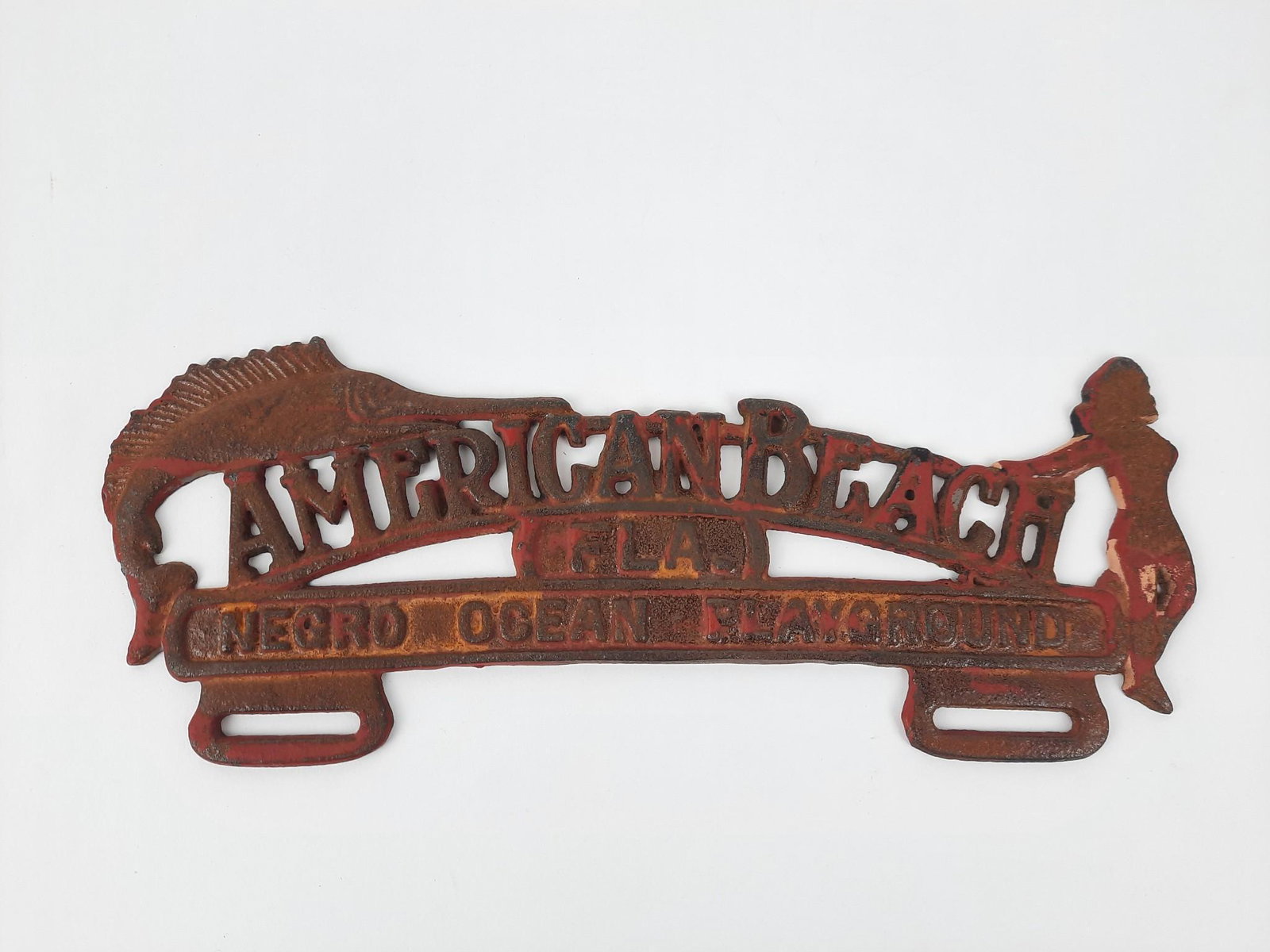 Negro " American Beach" License Plate Topper: American Beach FLA Negro Ocean Playground. Cast Iron. (11-1/2" wide x 4-1/2" high.American beach is located north of Jacksonville, Florida on Amelia Island. It was founded in 1935 by Floridaâ€™s 