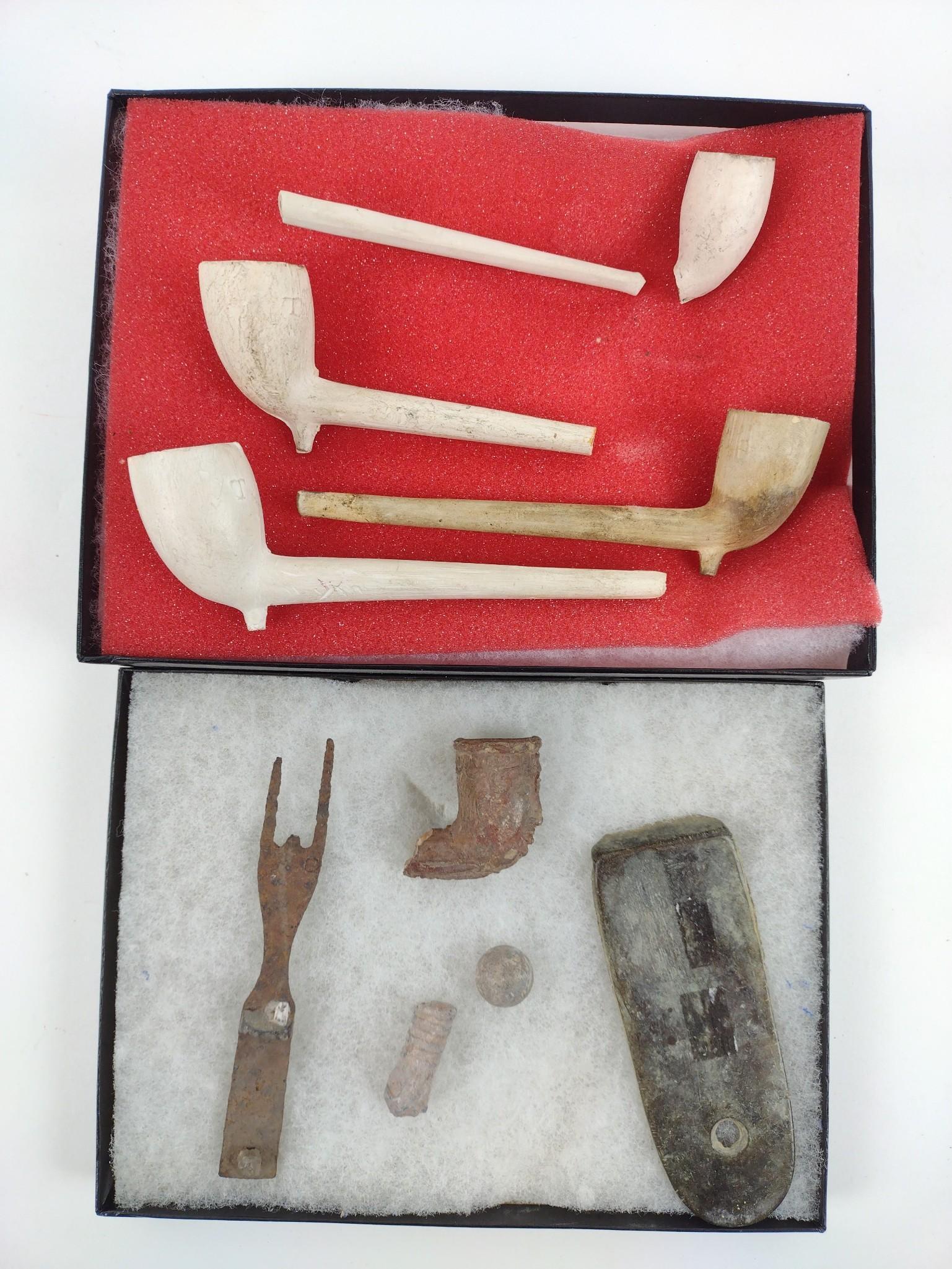 2 Riker Boxes With Artifacts: Includes Kaolin pipes, Clay pipe, banner stone, fork. MG. IMPORTANT: Before bidding, please read the terms and conditions. When you registered for the auction you agreed to these terms and will be req