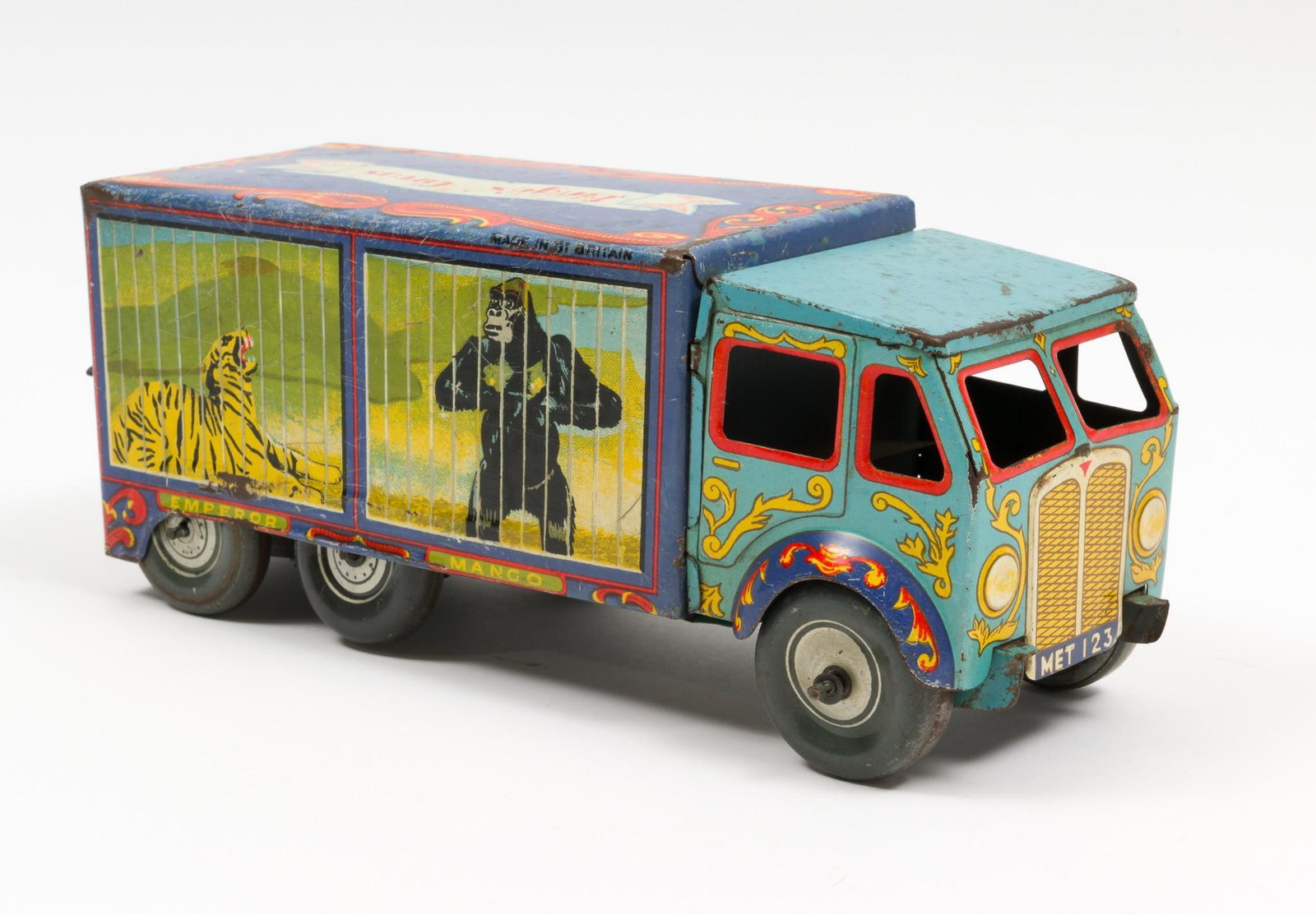 Bingo's Circus Wind Up Lorry: Marked made in Gt. Britain. Light blue cab with dark blue body. Decorated with four animals in cages with names underneath. Back of lorry opens. Overall wear including scratches, dents, paint wear, ba
