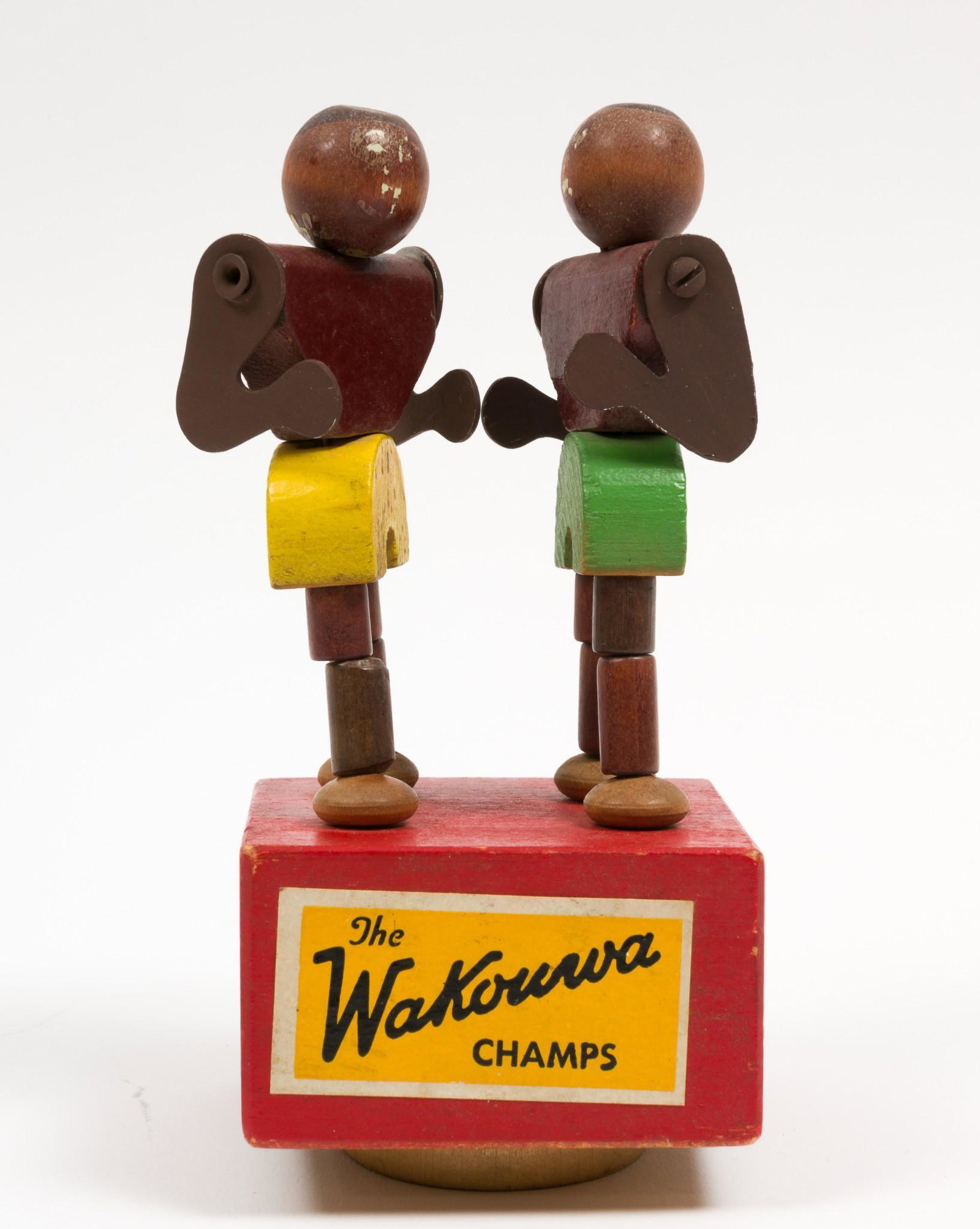The Wakourwa Champs Black Americana Boxers: Marked on bottom Made in U.S.A. Wakourwa. Wooden jointed boxers on red stand. Losses to paint on faces. 5-1/4" high. RM IMPORTANT: Before bidding, please read the terms and conditions. When you regist