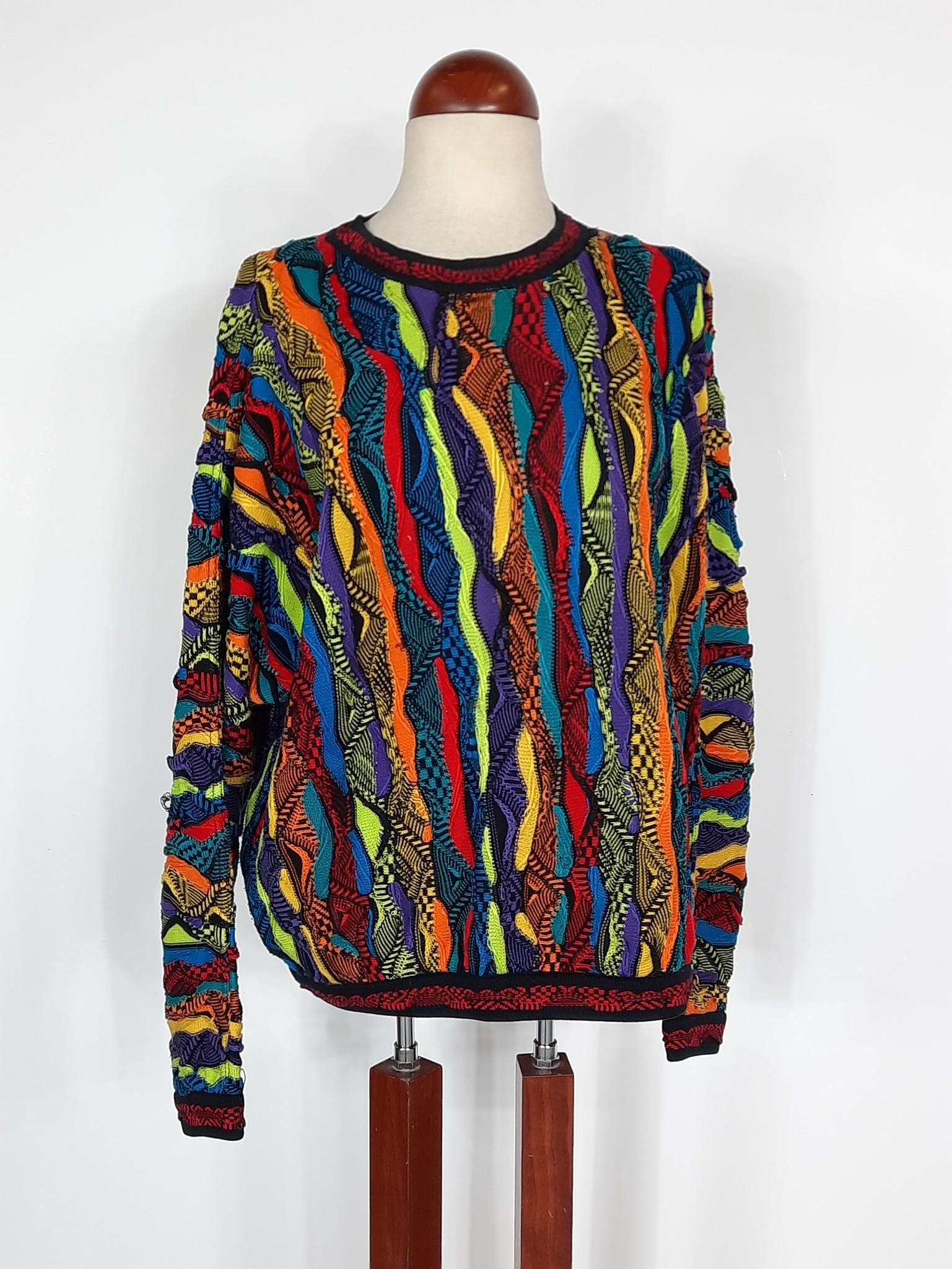Vibrant Coogi Australian Pull Over Sweater: Size medium. Some pulls to threading. LR IMPORTANT: Before bidding, please read the terms and conditions. When you registered for the auction you agreed to these terms and will be required to comply w