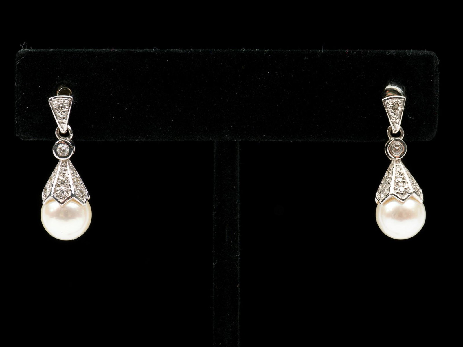 14K Diamond & Pearl Earrings: Stamped 14k white gold earrings each with bezel set 3 point diamond, seven bead set 1 point each diamonds, and 7.85 mm pearl. Total diamond weight approximately .20 CTW. 7/8" high. 2.4 dwt. EK IMPORTA