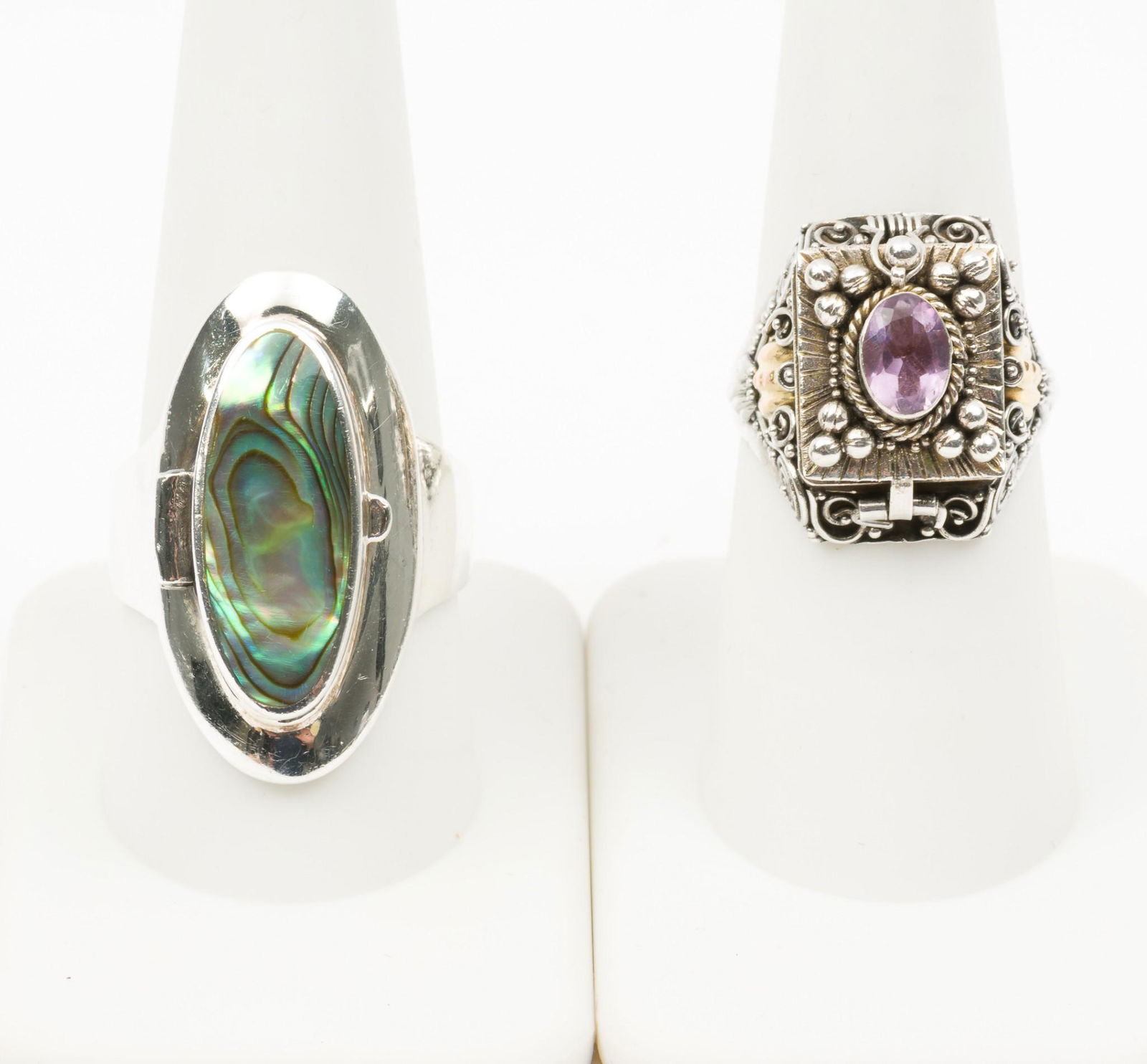 2 Sterling Poison Rings: Amethyst and abalone. Sizes 7-1/2 (amethyst) and 9-3/4. 3/4" to 1-1/4" wide. MH. IMPORTANT: Before bidding, please read the terms and conditions. When you registered for the auction you agreed to thes