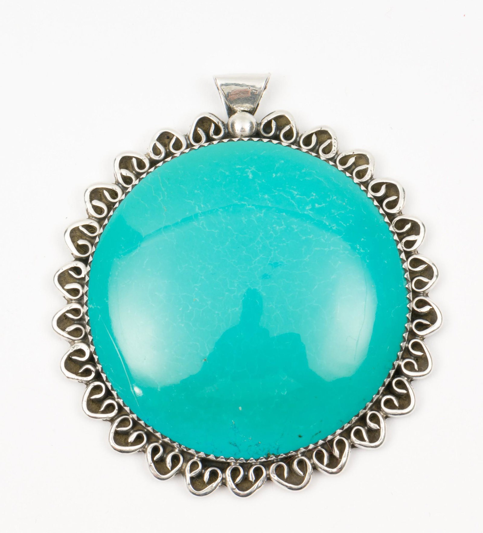 2 Inch Sharon Cisco Navajo Sterling & Turquoise Pendant: Stamped 925 and signed SC. 2" diameter; 2-1/4" long with bail. MH. IMPORTANT: Before bidding, please read the terms and conditions. When you registered for the auction you agreed to these terms and wi