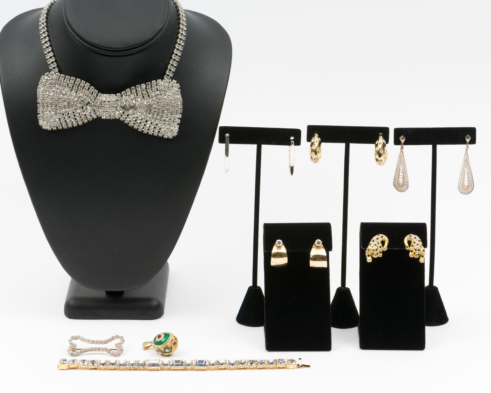 9 Pcs Costume Jewelry: Bow 4-1/2" wide on 14" choker. Bracelet 7-1/2" long. Earrings 3/4" to 1-3/4" long. IMPORTANT: Before bidding, please read the terms and conditions. When you registered for the auction you agreed to th
