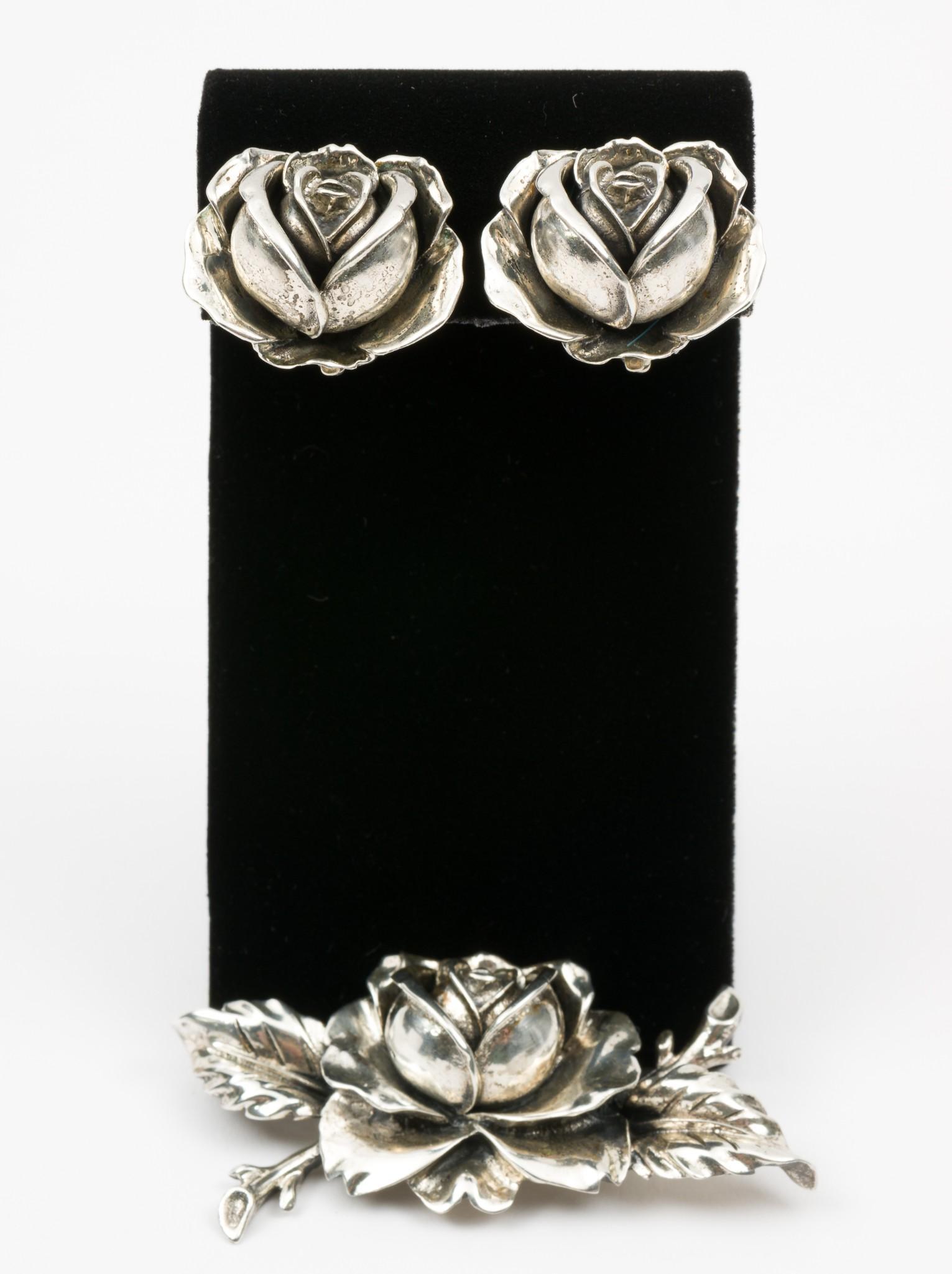 Alice Caviness Sterling Rose Brooch & Earrings: Brooch 2-2/3" wide. Clip on earrings 1" wide. MH. IMPORTANT: Before bidding, please read the terms and conditions. When you registered for the auction you agreed to these terms and will be required to