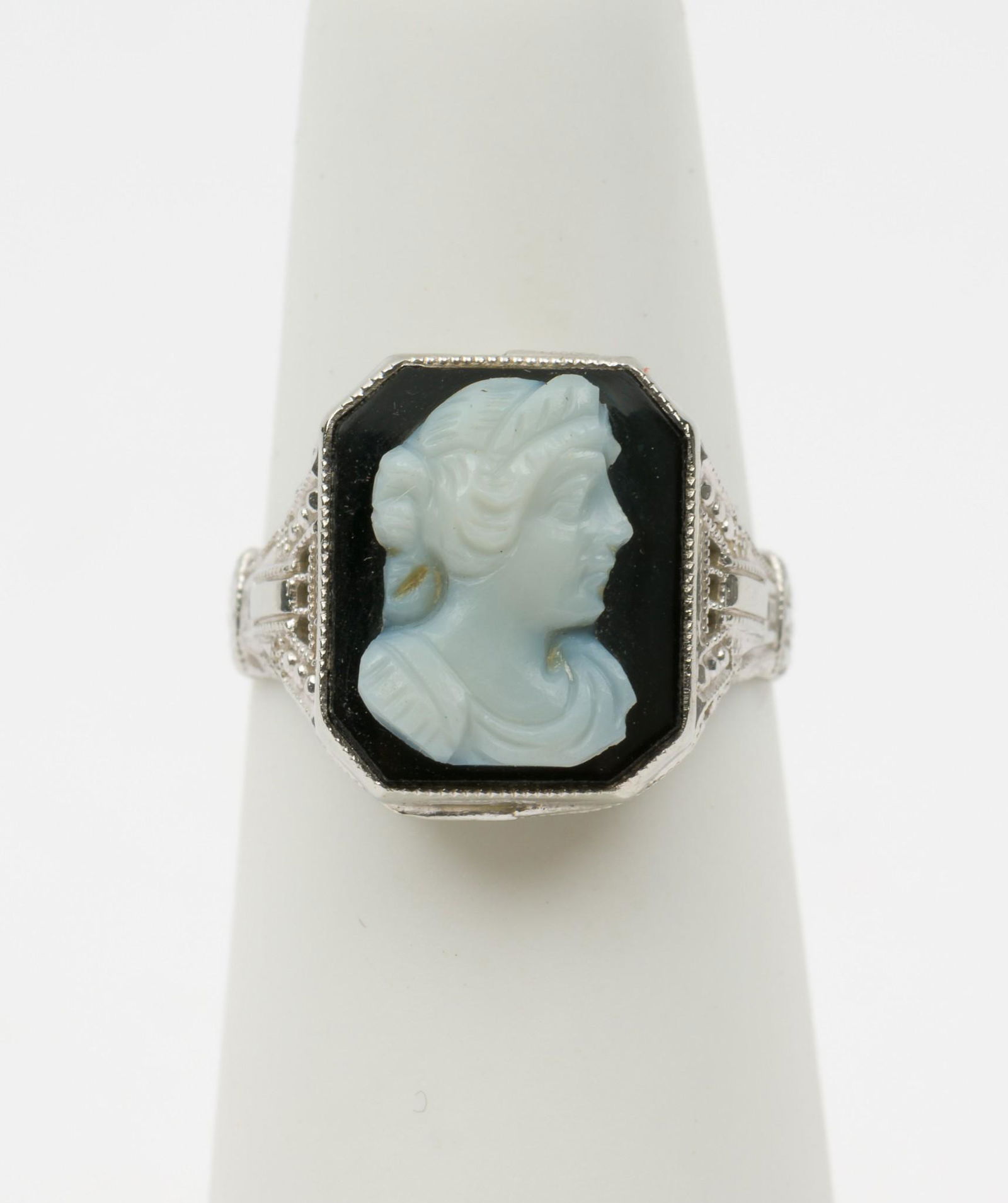 10K White Gold Cameo Ring: Stamped 10K. Size 4. 1/2" wide. 1.5 dwt. MH. IMPORTANT: Before bidding, please read the terms and conditions. When you registered for the auction you agreed to these terms and will be required to comp