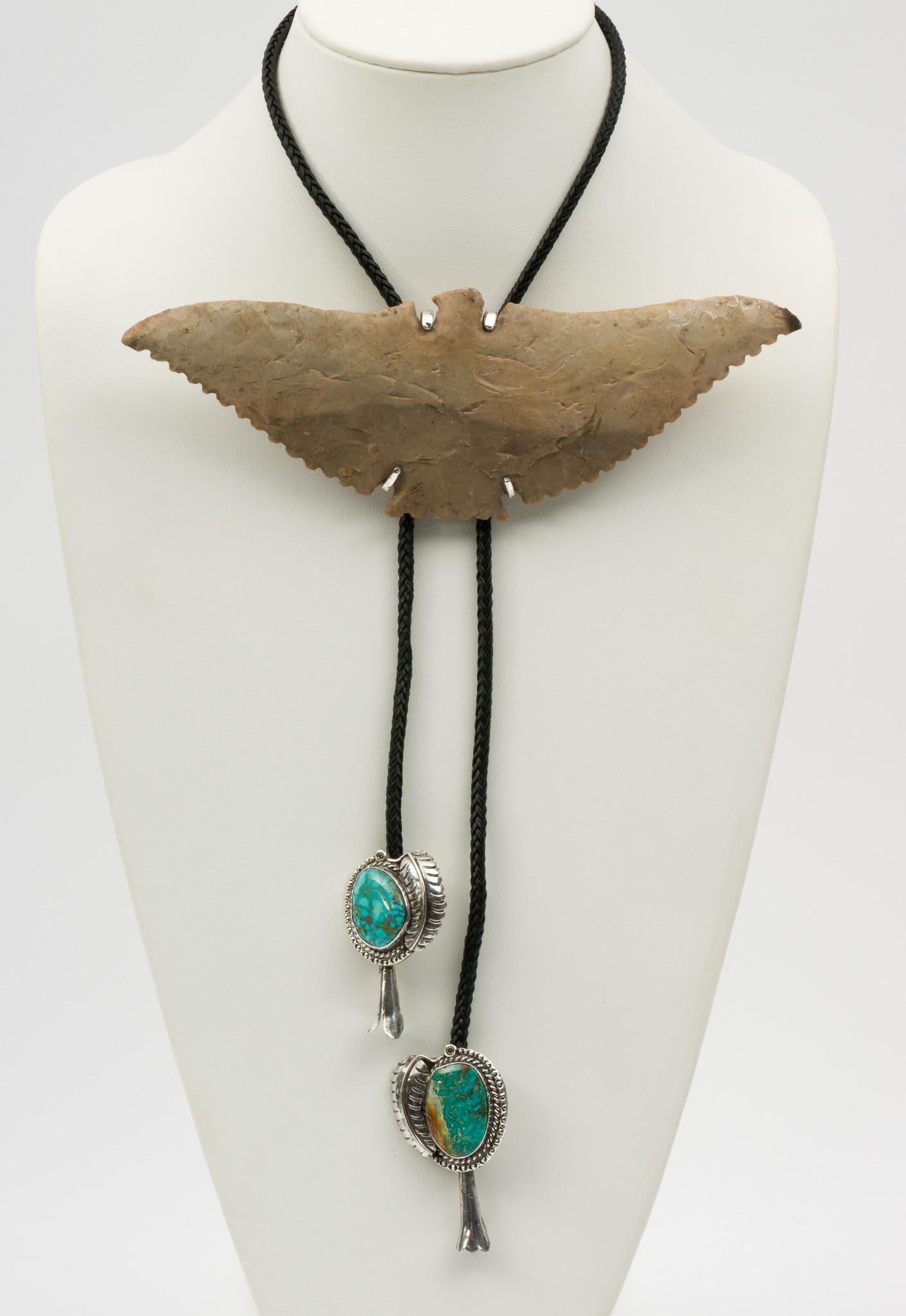 Navajo Bolo with Flint Eagle: With silver and turquoise pendants. Flint knapped eagle 7-1/2" wide. MH. IMPORTANT: Before bidding, please read the terms and conditions. When you registered for the auction you agreed to these terms 