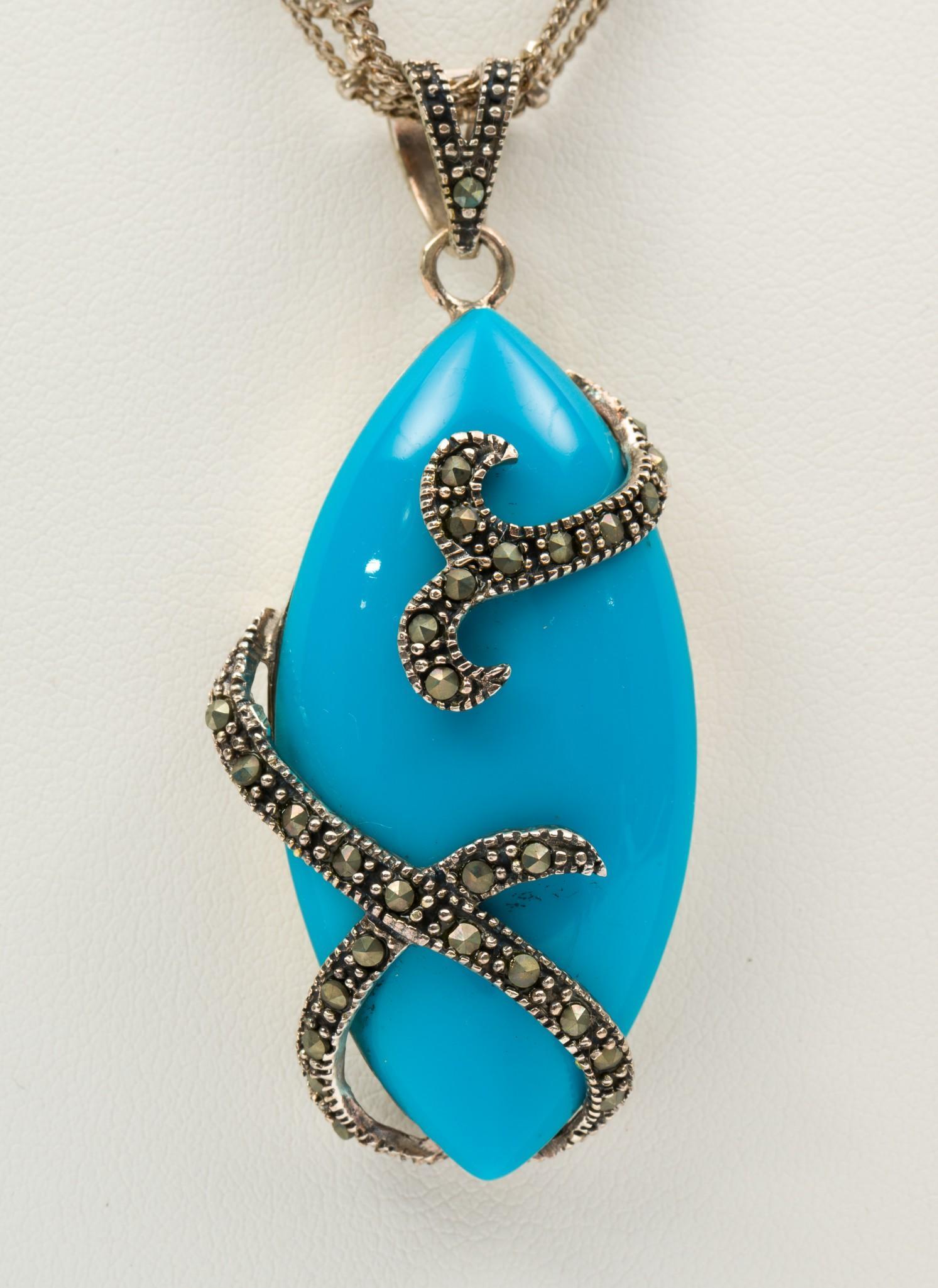 Sterling and Marcasite Necklace: With faux turquoise cabochon. Clasp marked 925. 16" long with 1-3/4" pendant. MH. IMPORTANT: Before bidding, please read the terms and conditions. When you registered for the auction you agreed to the
