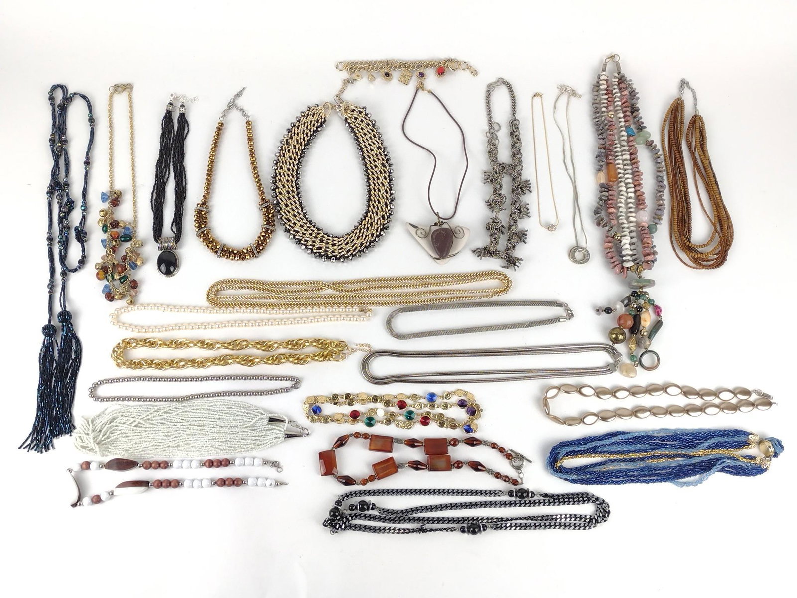 24 Costume Necklaces: Includes beads, faux pearls, stones, and more. Also includes a charm bracelet. Necklaces 17" to 55" long. Bracelet 6-7/8" long. DP IMPORTANT: Before bidding, please read the terms and conditions. When