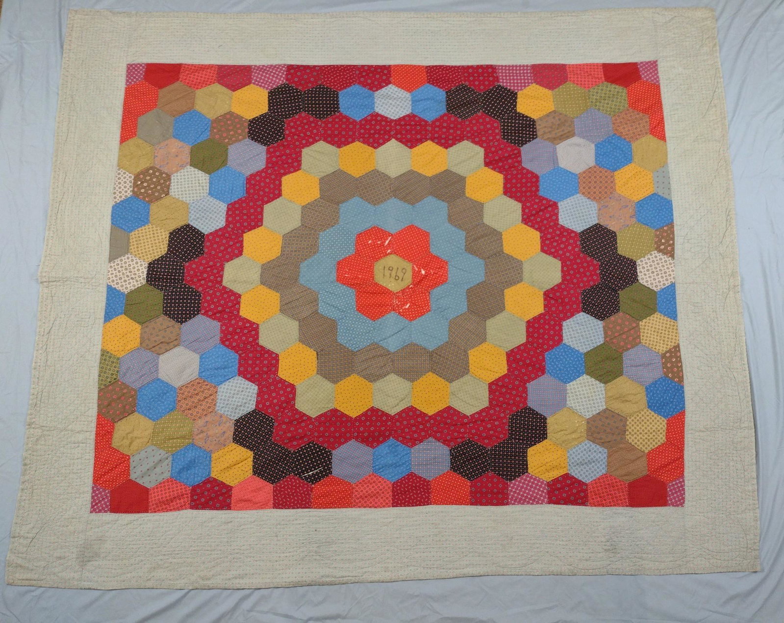 Vintage Quilt: 7'1" wide x 5'11-1/2" high. Some tears and losses. Dates 1969. DP. IMPORTANT: Before bidding, please read the terms and conditions. When you registered for the auction you agreed to these terms and wi