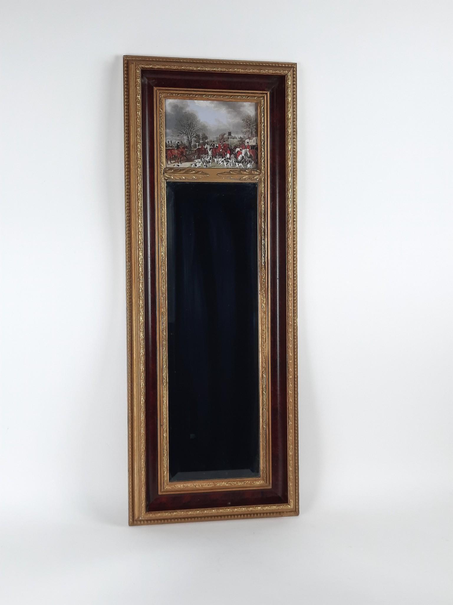The Bombay Co Hunt Scene Mirror: Overall with frame 36" high x 13-1/2" wide. LR IMPORTANT: Before bidding, please read the terms and conditions. When you registered for the auction you agreed to these terms and will be required to co