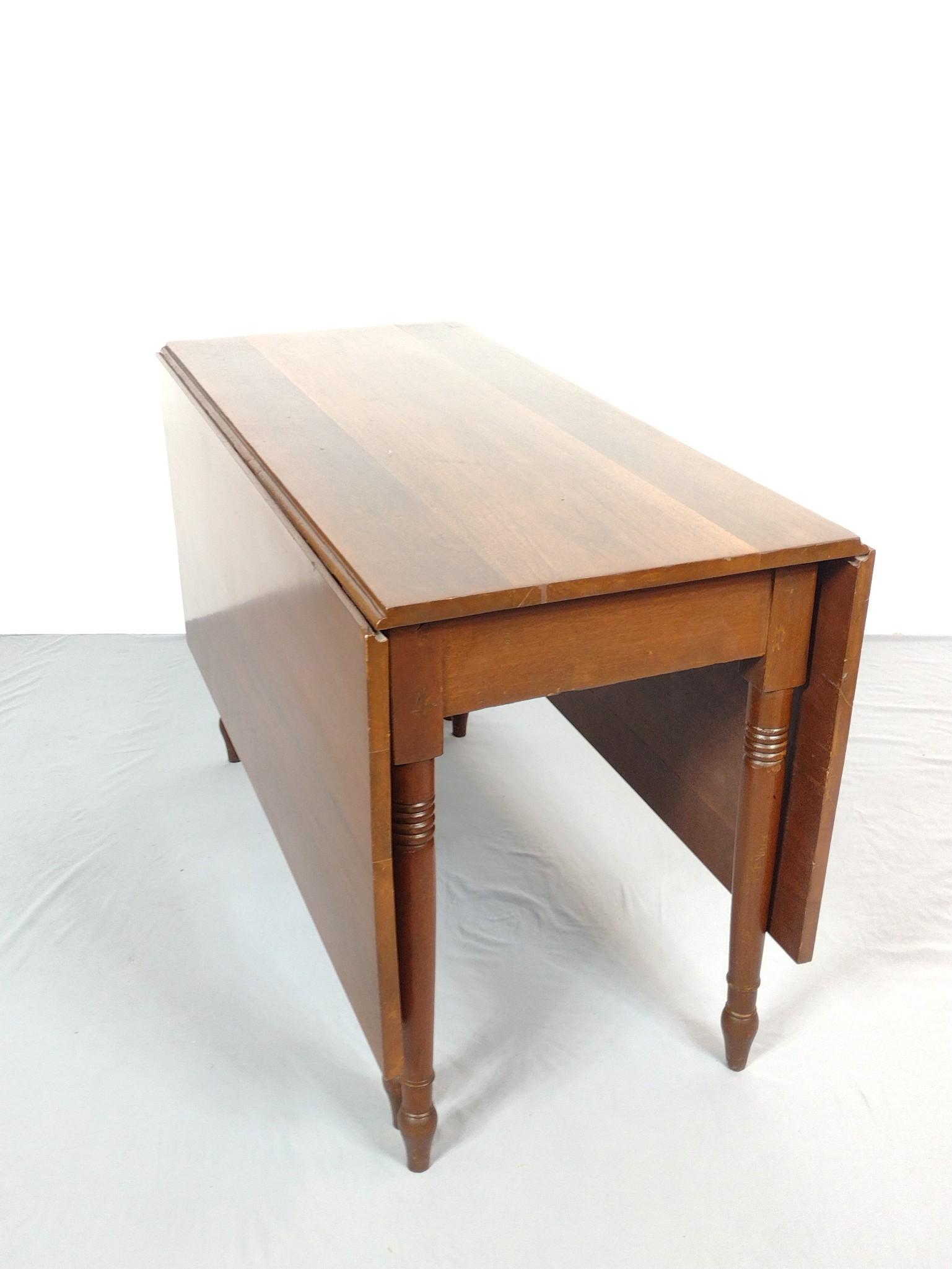 Drop Leaf Table: Open 60-1/2", closed 21-1/2" wide X 46" deep X 30" high. Has some light scratches. MG. IMPORTANT: Before bidding, please read the terms and conditions. When you registered for the auction you agreed t