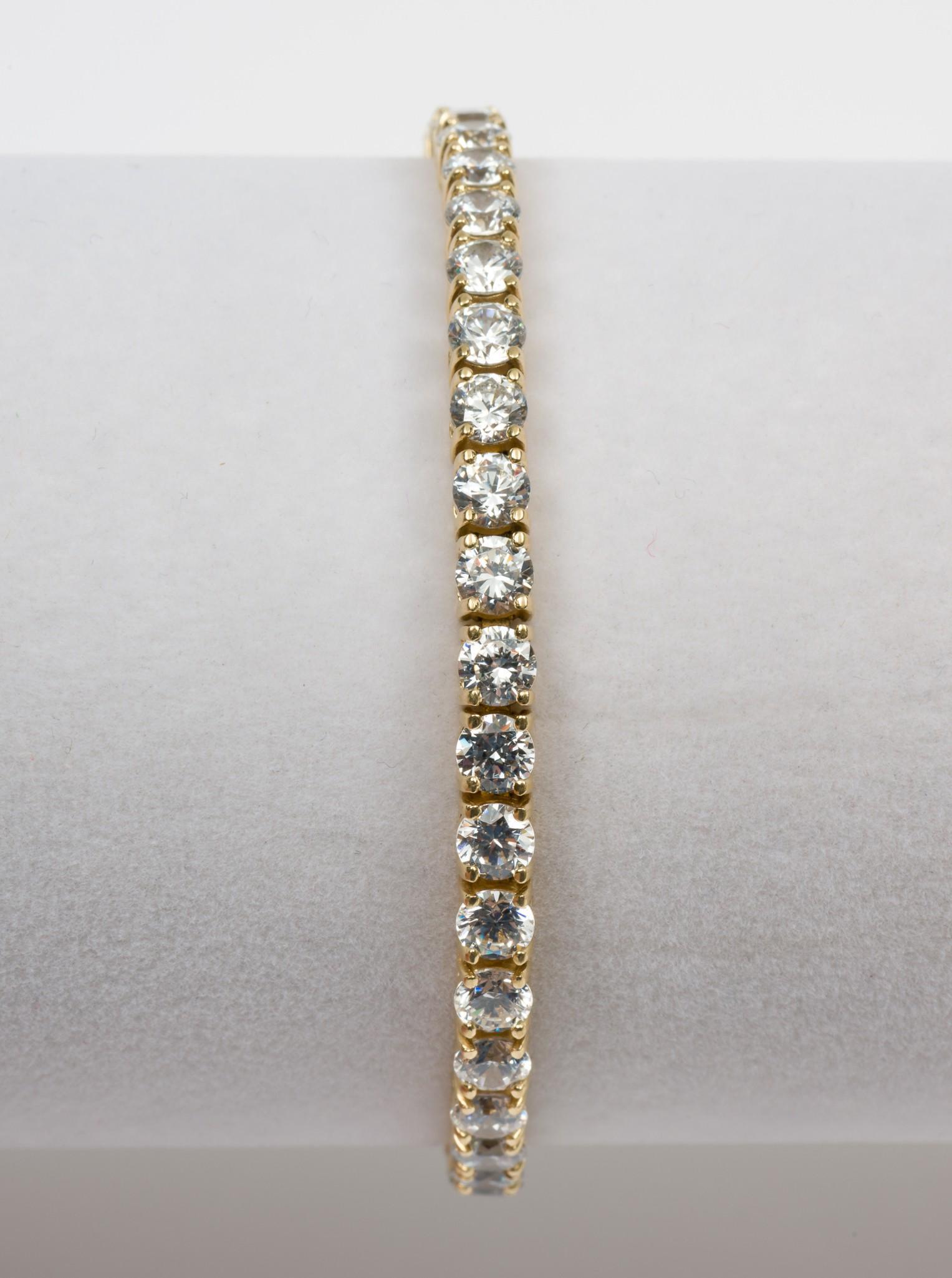 14K Gold & 19 CTW CZ Tennis Bracelet: Stamped 14K bracelet set with thirty-eight approximately .50 carat each round cut cubic zirconia. 7-3/4" long x 1/8" wide. 10.3 dwt. DP/EK IMPORTANT: Before bidding, please read the terms and conditio