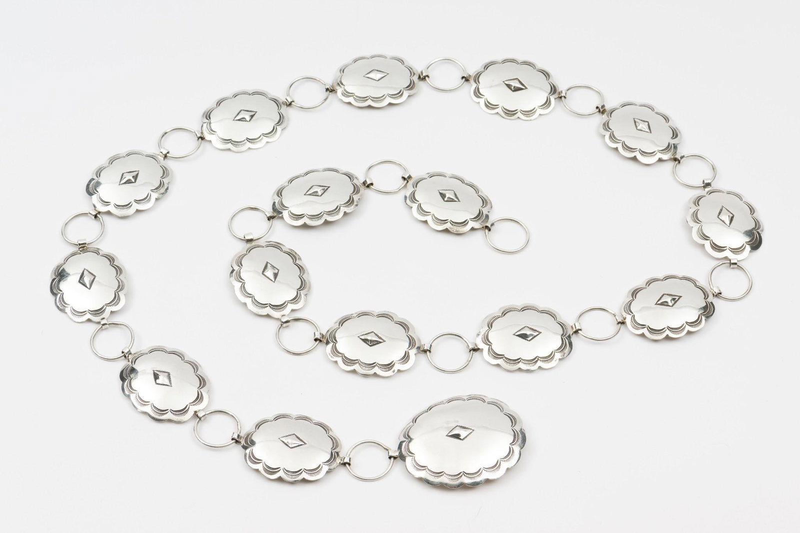 Native American Silver Concho Belt: 42" long. Conchos 2-1/8" wide and 1-1/2" wide. MH. IMPORTANT: Before bidding, please read the terms and conditions. When you registered for the auction you agreed to these terms and will be required t