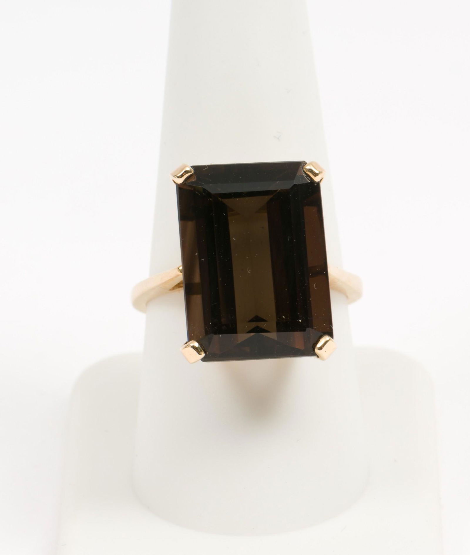 14K Gold & 14.5 Ct Smoky Quartz Ring: 14K stamped ring set with emerald step cut smoky quartz, approximately 14.5 carats (13mm x 18mm). 4.8 dwt. Size 9. EK IMPORTANT: Before bidding, please read the terms and conditions. When you register