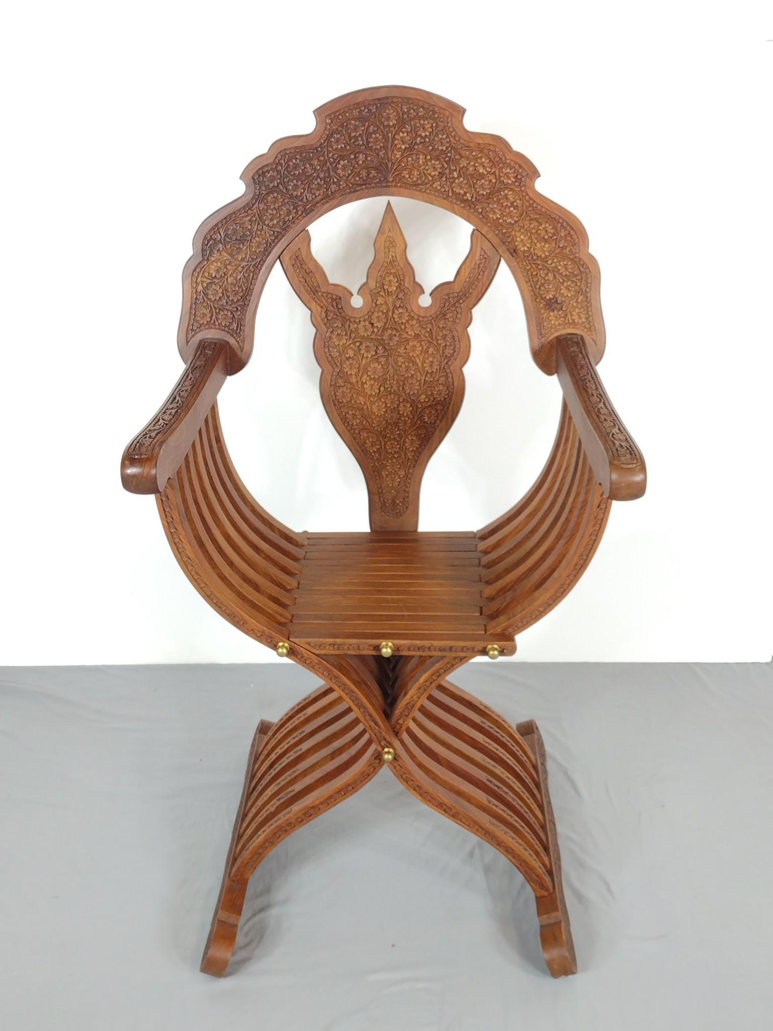 Carved Savonarola Arm Chair: 26-1/2" wide X 23" deep X 46-3/4" high. MG. IMPORTANT: Before bidding, please read the terms and conditions. When you registered for the auction you agreed to these terms and will be required to compl