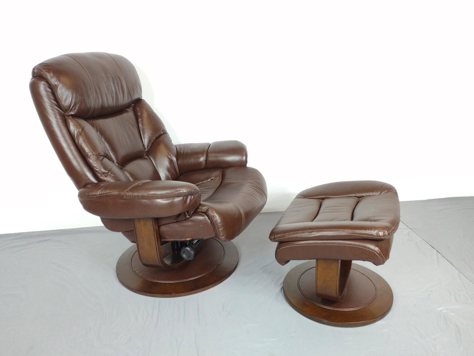 Leather Recliner With Ottoman: Made by Man Wah Furniture Co. Chair 33" wide X 32" deep X 41" high. Ottoman 22" wide X 18" deep X 18-1/2" high. Has some light scratches. MG. IMPORTANT: Before bidding, please read the terms and condi
