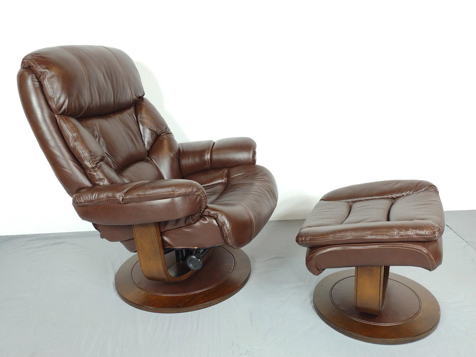 Leather Recliner With Ottoman: Made by Man Wah Furniture Co. Chair 33" wide X 36" deep X 41" high. Ottoman 22" wide X 18" deep X 19" high. Has some light scratches. MG. IMPORTANT: Before bidding, please read the terms and condition
