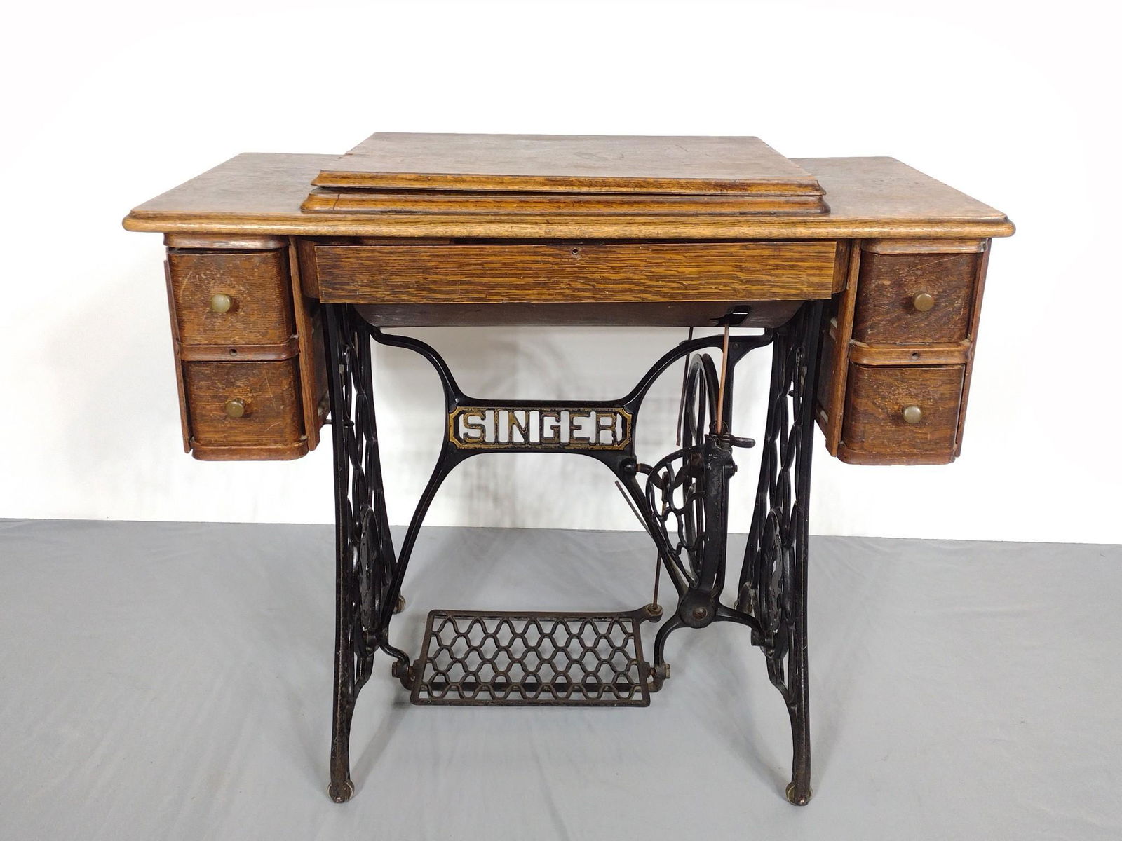 Singer Treadle Sewing Machine: Not working. 36-1/4" wide X 18" deep X 31" high. Has finish loss and scratches. MG. IMPORTANT: Before bidding, please read the terms and conditions. When you registered for the auction you agreed to t