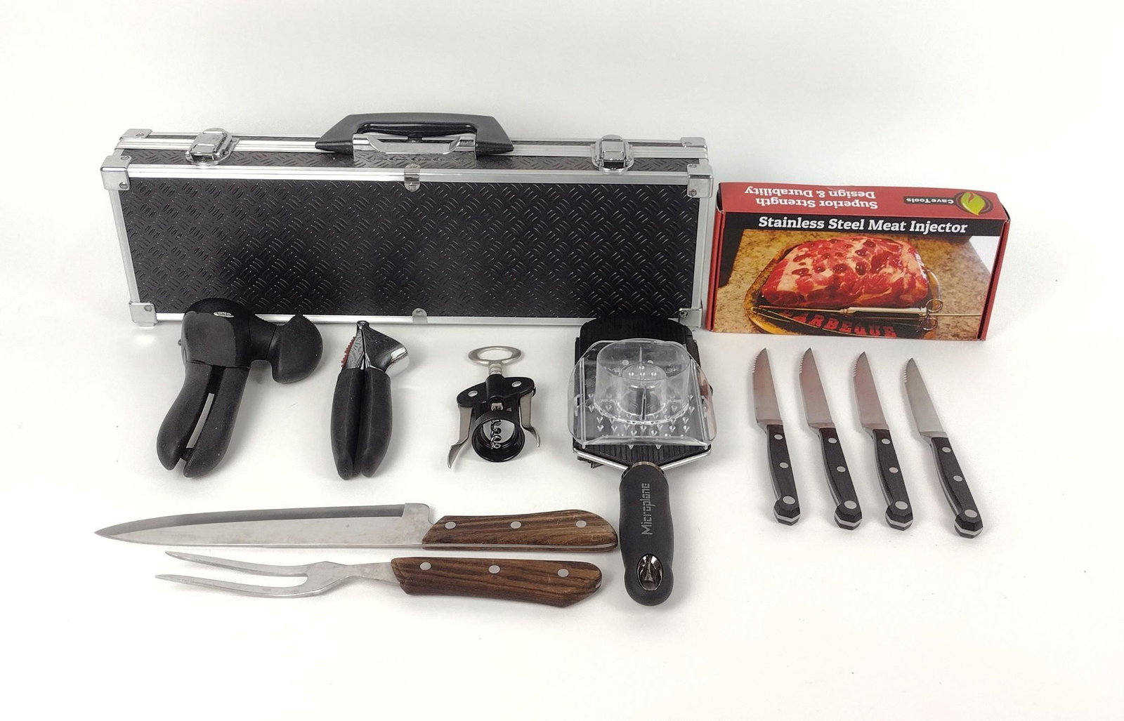 12 Kitchen Tools incl Grilling Set: Includes Microplane handheld vegetable slicer, can opener, stainless steel meat injector, steak knives, wine opener, and garlic press. MEG IMPORTANT: Before bidding, please read the terms and conditio