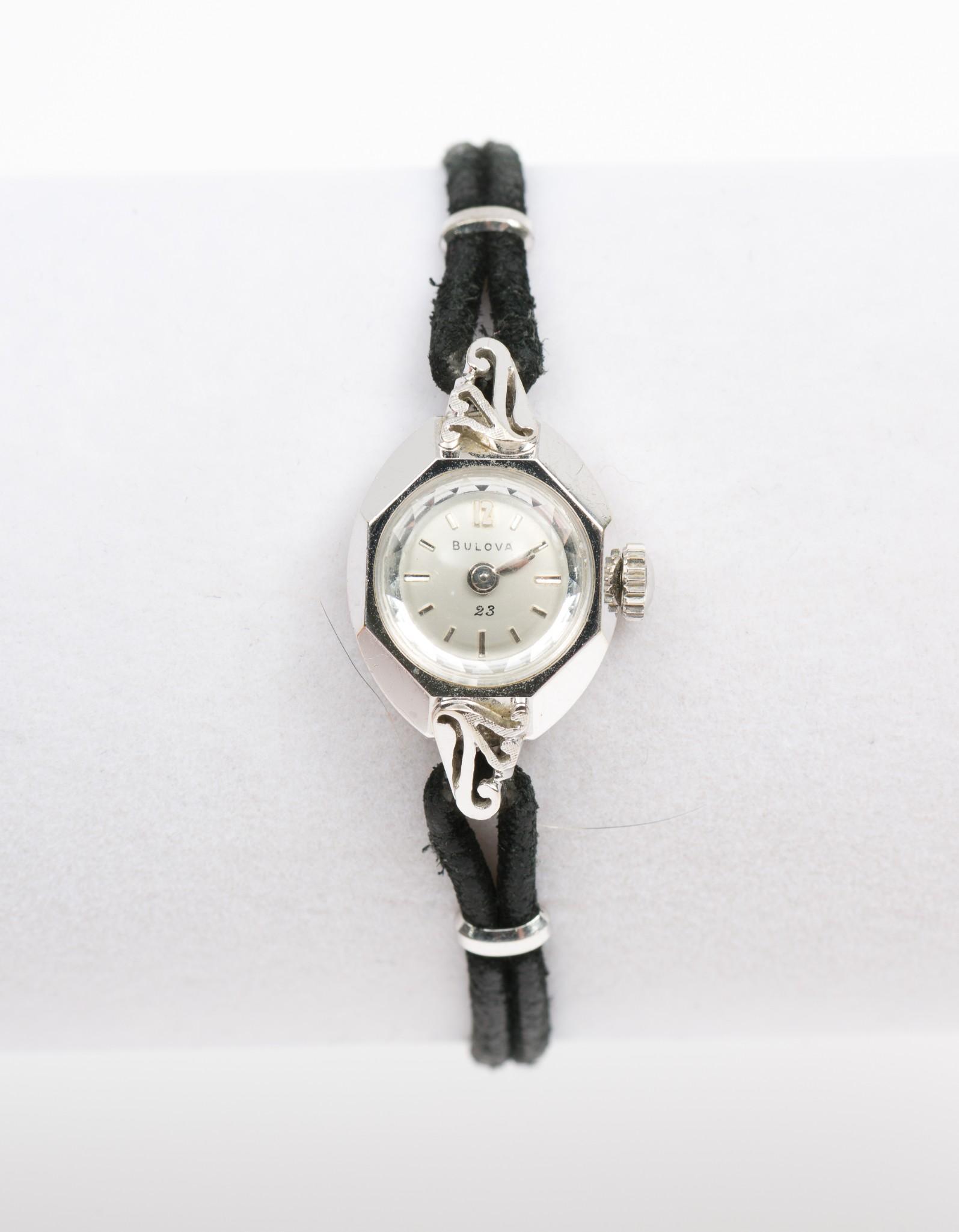 Bulova 14K Case Watch: 23J movement. Hands set. With black cord band and safety chain. 1" lug to lug. Running. MH. IMPORTANT: Before bidding, please read the terms and conditions. When you registered for the auction you agr