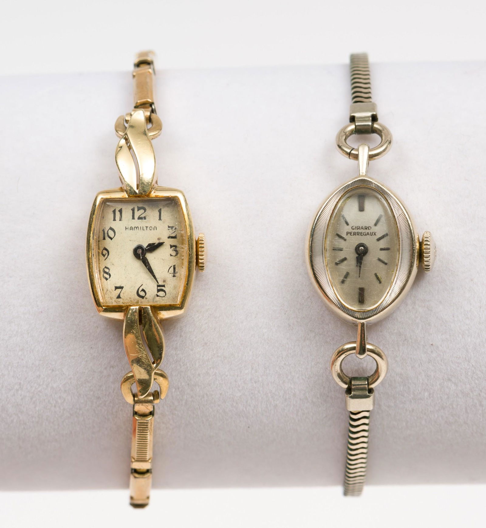 Hamilton & Girard Perregaux 14K Ladies Wrist Watches: Hamilton 17J movement in case marked 14k on elastic Kreisler band. Girard Perregaux 17J watch in 14k white gold case on gold-filled band. 1-1/8" to 1-5/8" lug to lug. Hands set on both; neither run. M