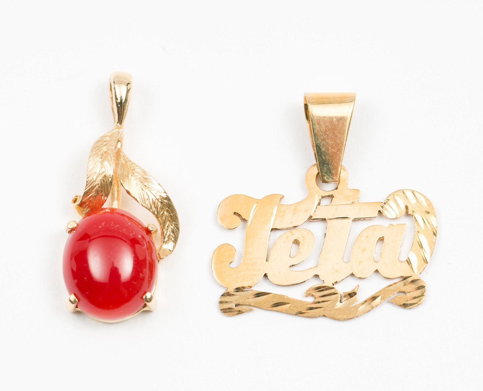 2 14K Pendants: Includes carnelian and "Jeta". Both marked 14k. 5/8" to 1" high. 2.3 total dwt. DP. IMPORTANT: Before bidding, please read the terms and conditions. When you registered for the auction you agreed to t