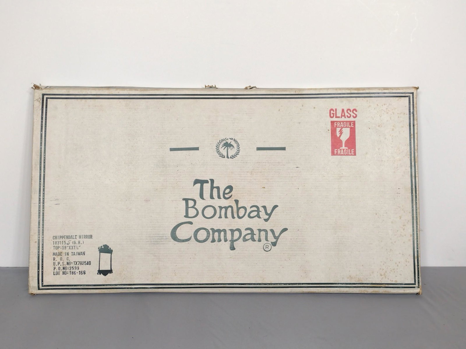 The Bombay Company Chippendale Mirror: Factory sealed. 19" wide X 38" high. MG. IMPORTANT: Before bidding, please read the terms and conditions. When you registered for the auction you agreed to these terms and will be required to comply w