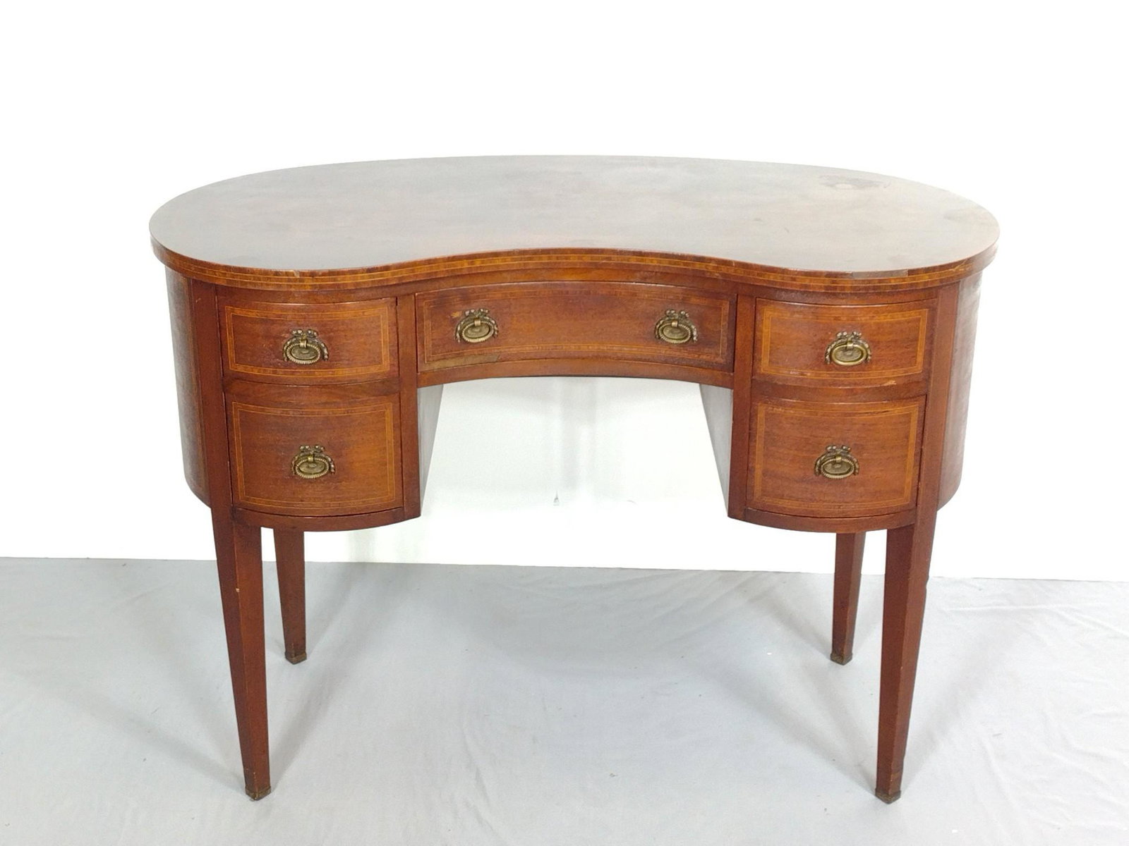 Kidney Form Desk: 42" wide X 24" deep X 30" high. Has some scratches and areas of veneer loss. MG. IMPORTANT: Before bidding, please read the terms and conditions. When you registered for the auction you agreed to thes