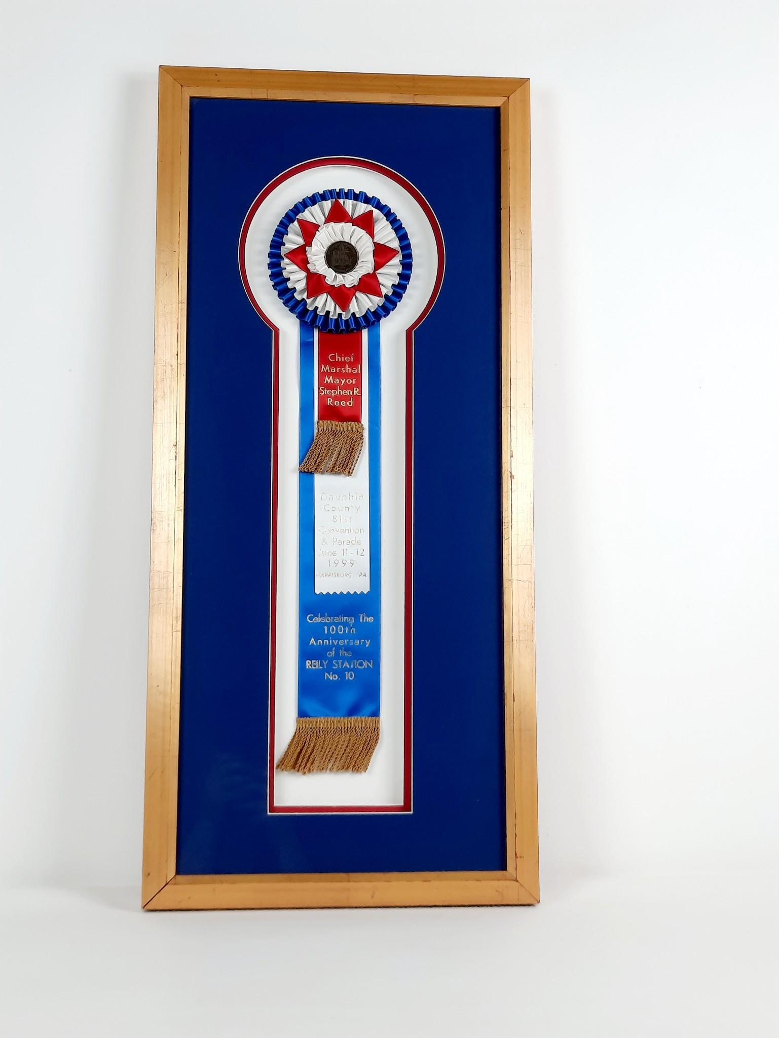 1999 Dauphin County 100th Anniversary of Reily Station Ribbon: Chief Marshal Mayor Stephen R Reed. Overall with frame 30-1/2" high x 14" wide. LR The item(s) in this lot are being sold from the Estate of Stephen Reed. IMPORTANT: Before bidding, please read the te