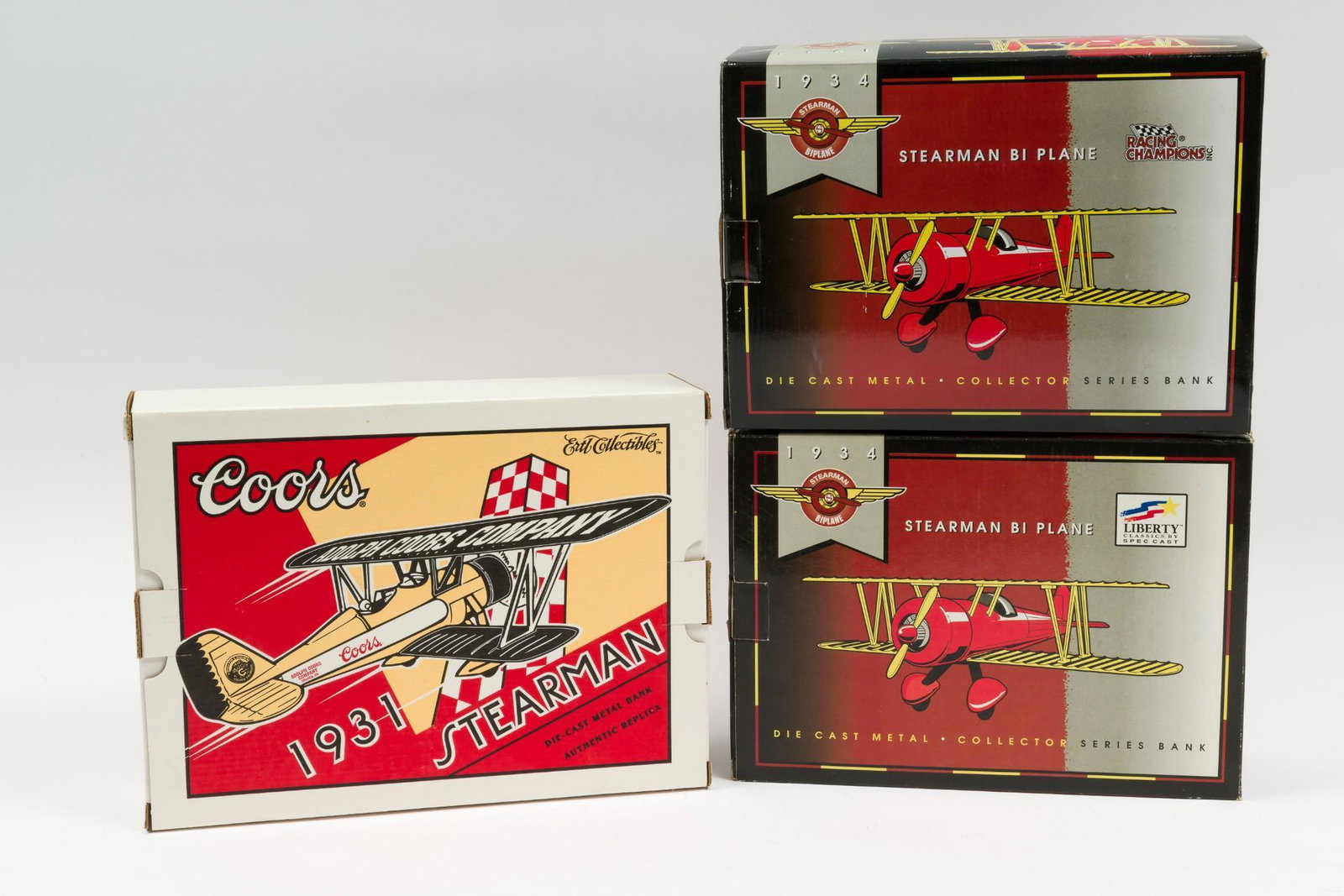 3 Stearman Diecast Airplane Collector Series Banks: Includes Stearman Bi Plane Racing Champions Ford 1934 stock #00500 and 1934 Stearman Bi Plane stock #37529. Both in original boxes. Also includes Stearman Ertl Collectibles Coors 1931 authentic replic