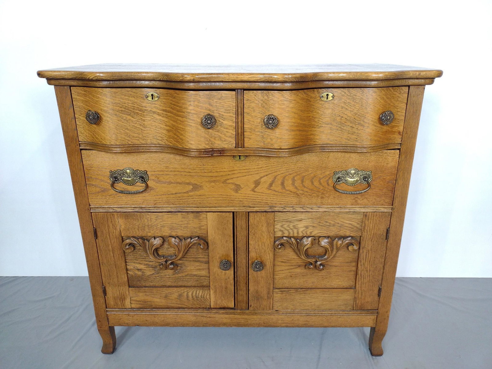 Oak Sideboard: 42" wide X 23" deep X 38-1/4" high. Has some light scratches. MG. IMPORTANT: Before bidding, please read the terms and conditions. When you registered for the auction you agreed to these terms and wil