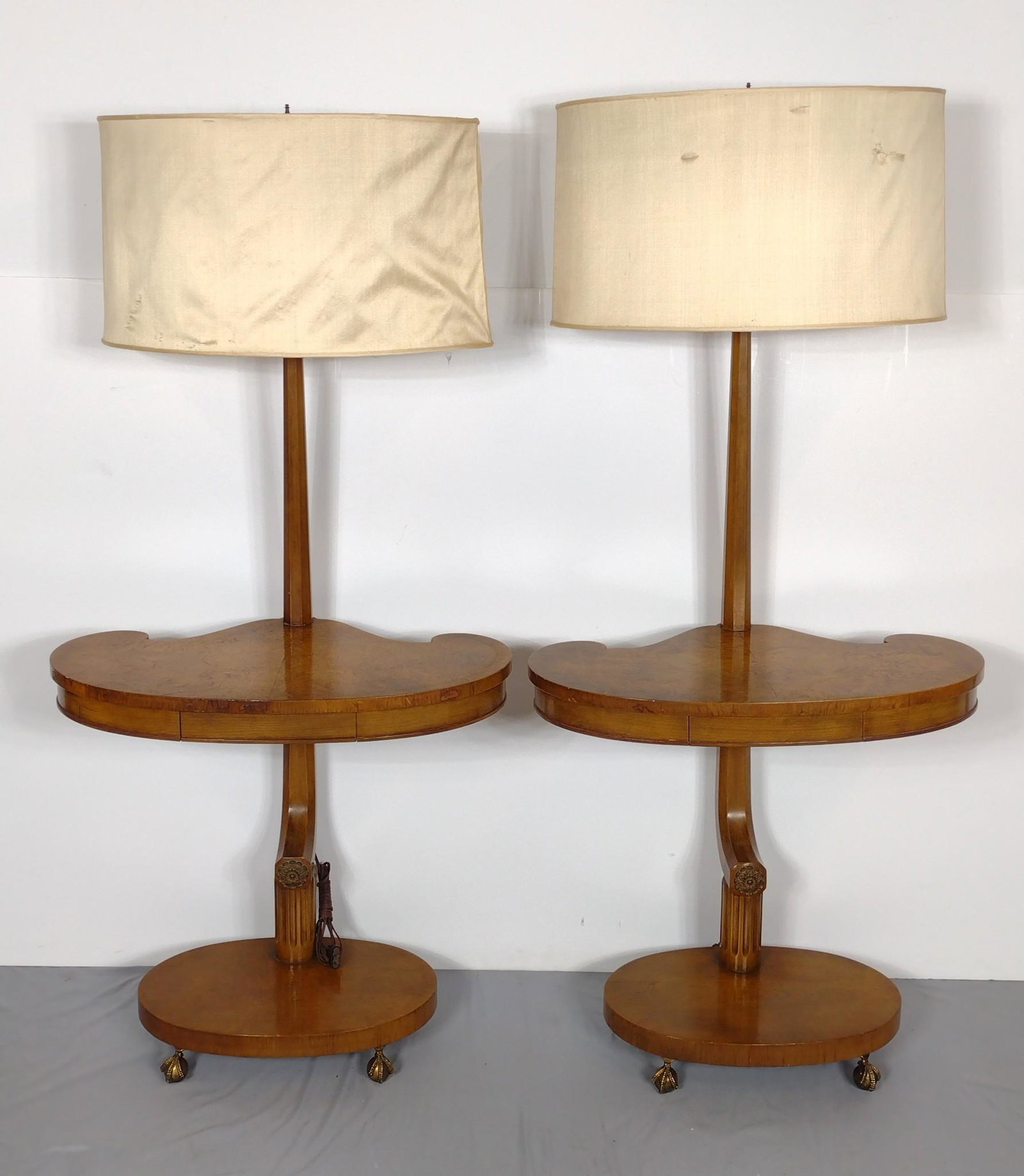 Pair Of Single Drawer Lamp Tables With Burl Veneer: Working. Shades formed to match lamp table base. 28-1/4" wide X 21" deep X 61" high. Both have some scratches. One has some veneer loss. MG. IMPORTANT: Before bidding, please read the terms and condit
