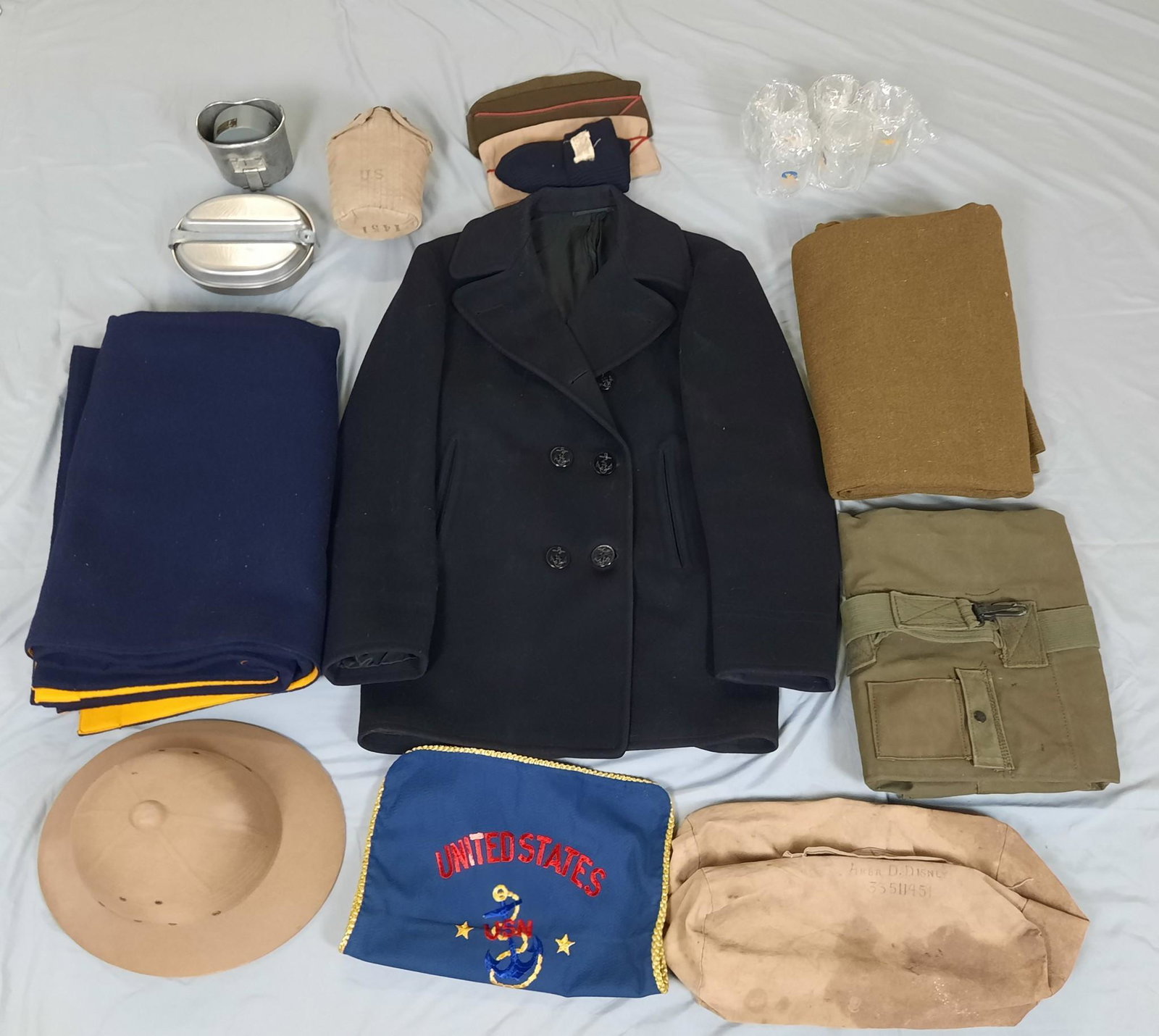 Large Grouping Naval Clothing, Blanket and Mess Kits: Includes Naval dress jacket, mess kit, hat, blanket and shoulder bags. LR IMPORTANT: Before bidding, please read the terms and conditions. When you registered for the auction you agreed to these terms