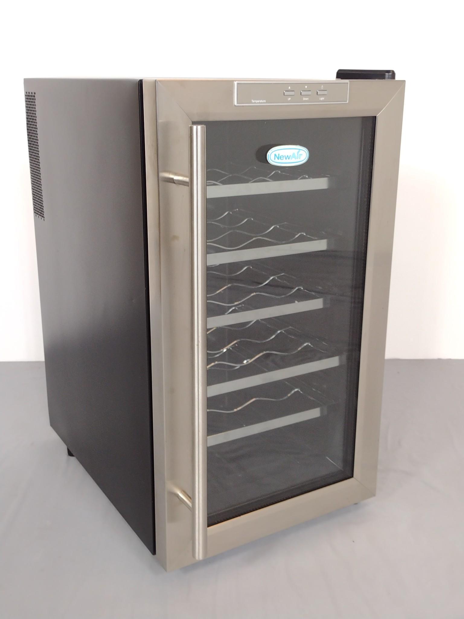 NewAir Wine Cooler: Working. Model AW-181E. 14" wide X 21-1/2" deep X 25" high. MG. IMPORTANT: Before bidding, please read the terms and conditions. When you registered for the auction you agreed to these terms and will 