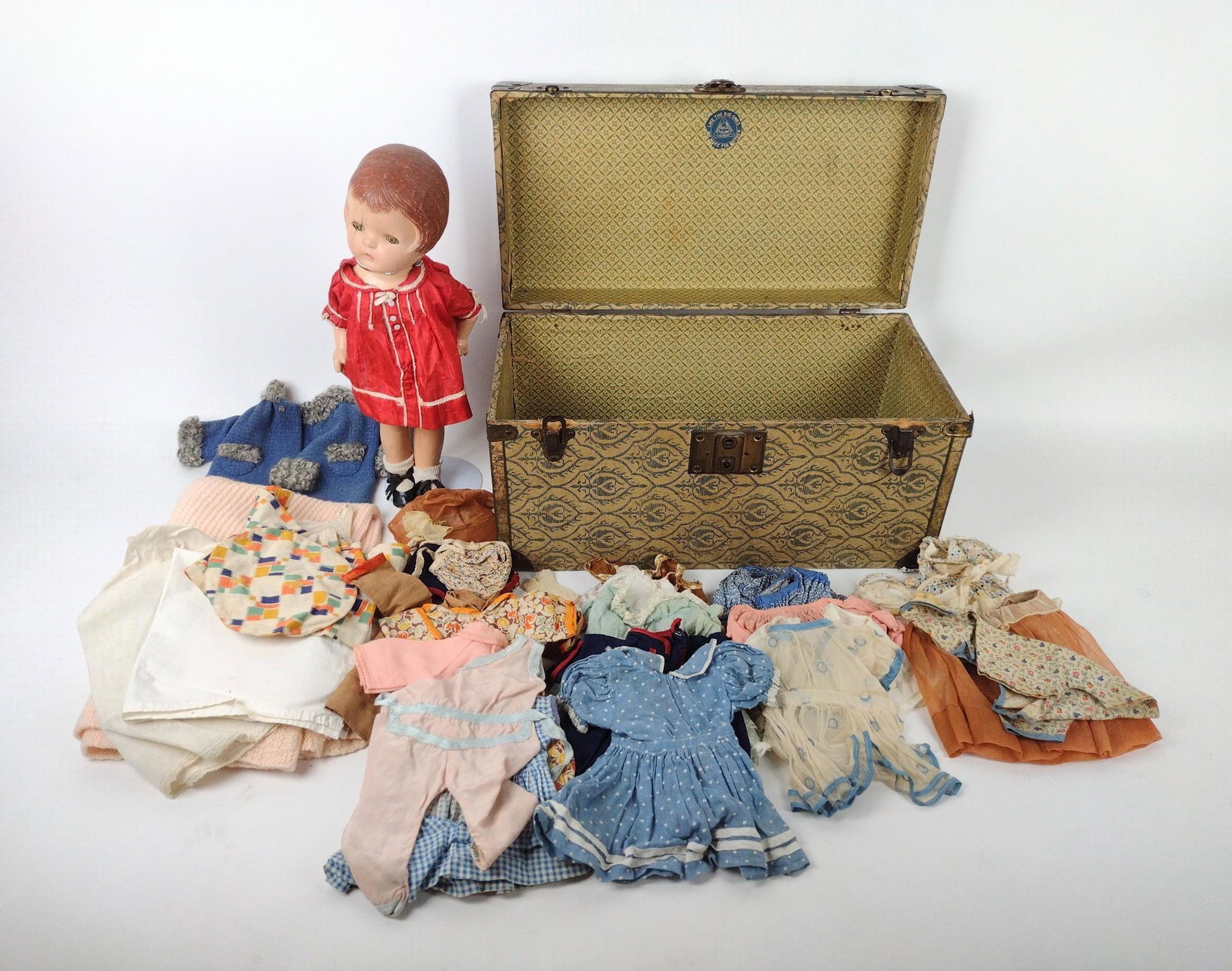 1931 Patsy Doll w/ Clothes & Case: Composite doll. 15" high. Cracking throughout. RM IMPORTANT: Before bidding, please read the terms and conditions. When you registered for the auction you agreed to these terms and will be required to