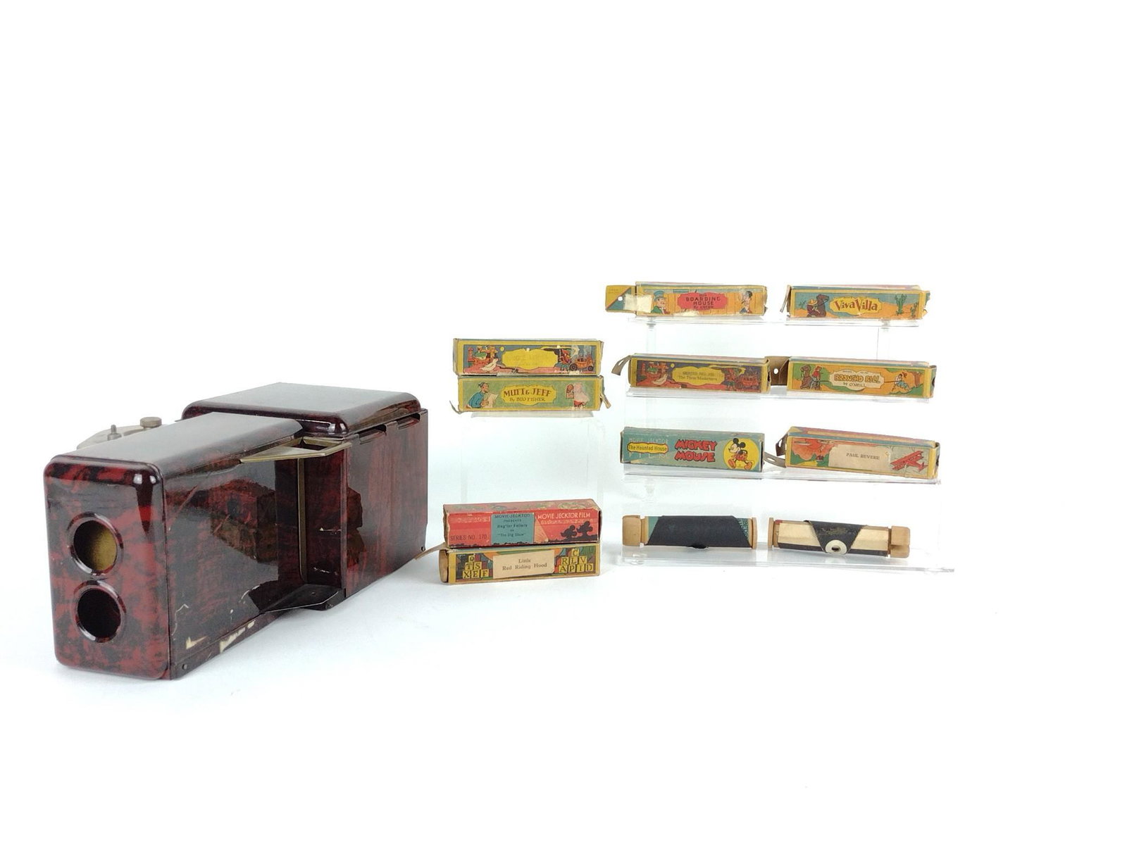 Movie Projector & 12 Rolls of Film: Working. Unmarked. Films include Mickey Mouse, Mutt & Jeff, and more. DP. IMPORTANT: Before bidding, please read the terms and conditions. When you registered for the auction you agreed to these terms
