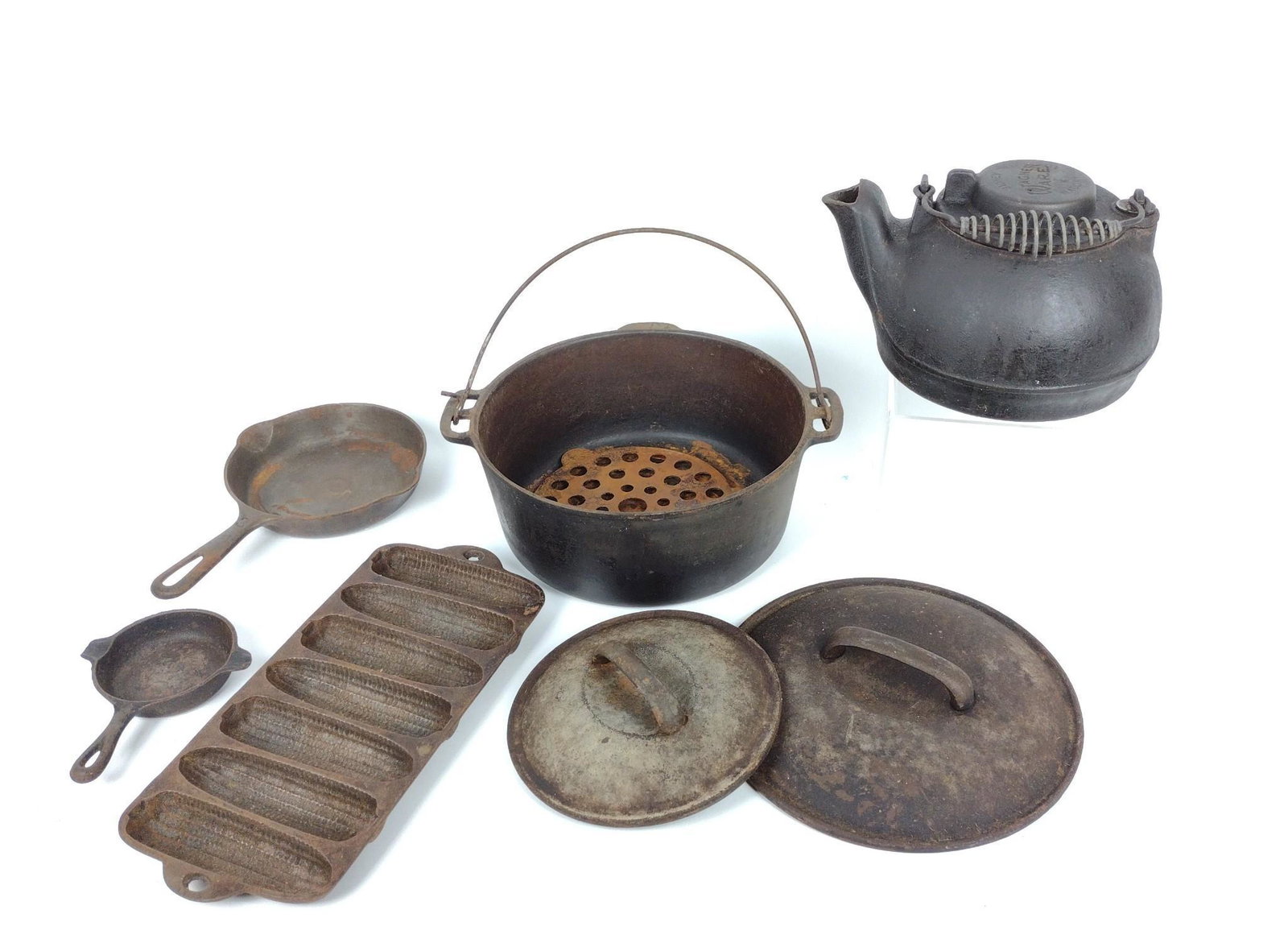 8 Pcs Wagner & Griswold Cast Iron: 3-3/4" to 10-1/4" diameter x 1" to 4-1/4" high. All with rust and pitting. Lids are a marriage to vases and do not fit securely. RM IMPORTANT: Before bidding, please read the terms and conditions. Whe