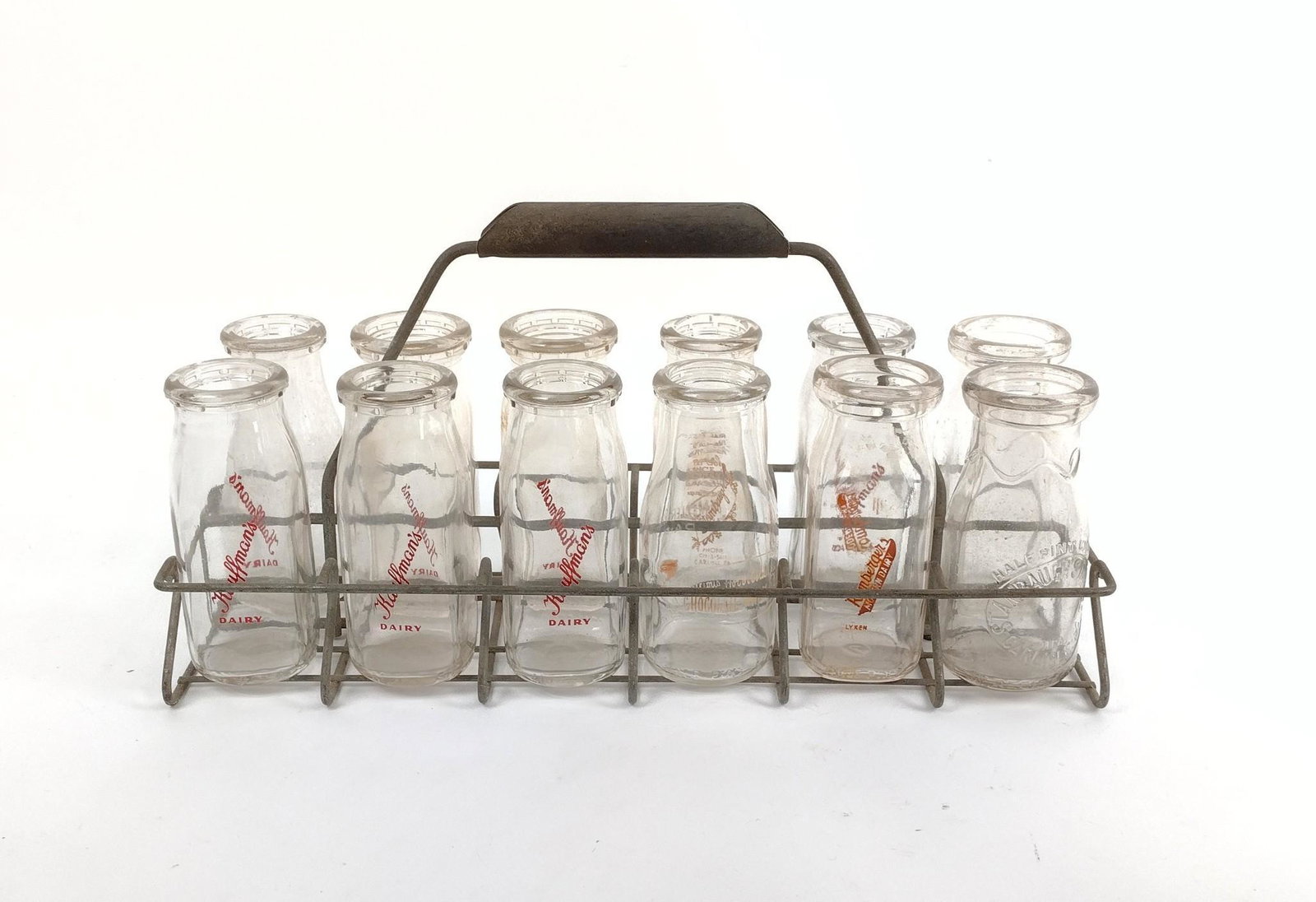 12 Pennsylvania Glass Milk Half Pints & Carrier: Includes glasses from Carlisle, PA and Hamburg, PA Dairy farms. 1-3/4" to 2-1/4" diameter X 5-1/4 to 5-1/2" high. MEG IMPORTANT: Before bidding, please read the terms and conditions. When you register